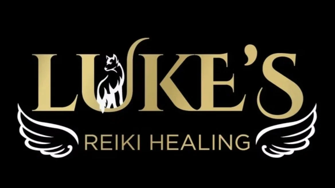 Logo for Luke's Reiki Healing featuring gold text, a black and white wolf head, and white angel wings.