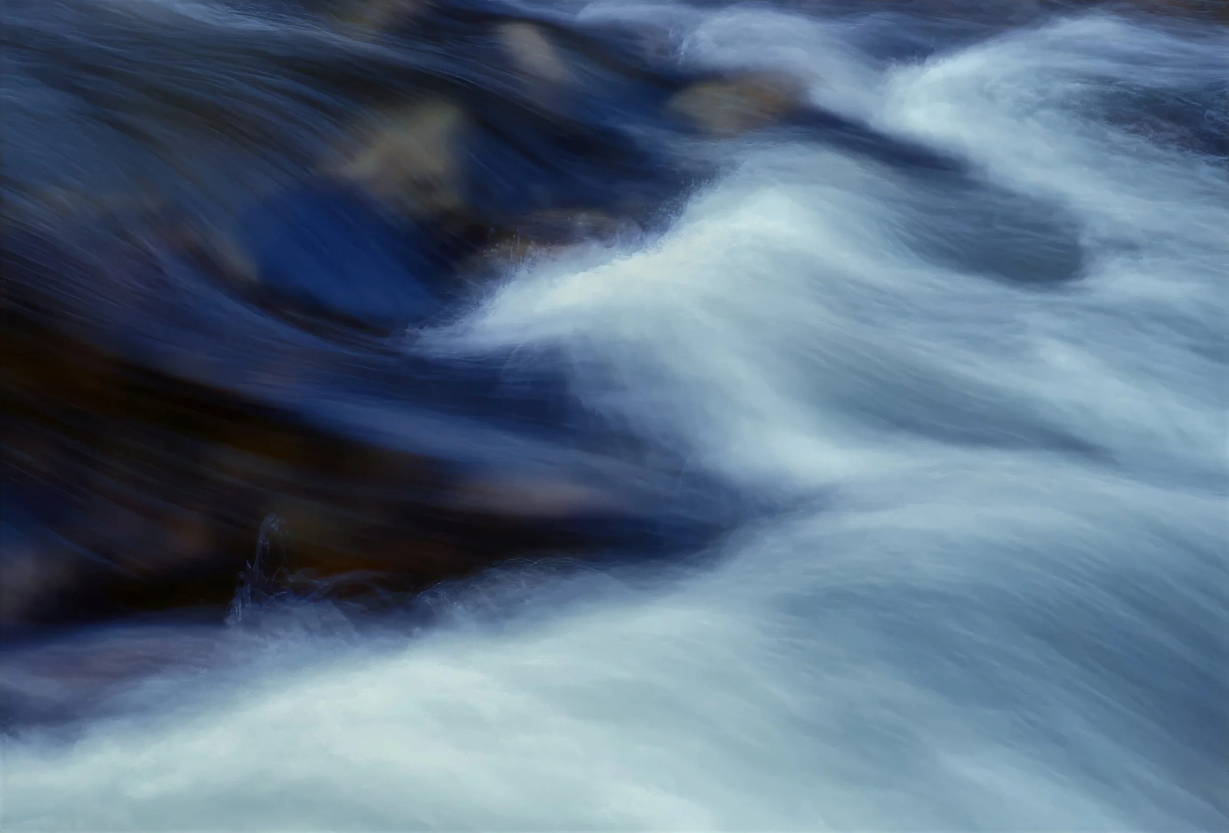 Merced River, Yosemite - Fast-moving river water with white foam and dark blue waves.