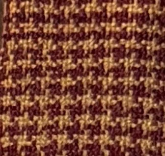 Close-up of textured fabric with a brown and black pattern.