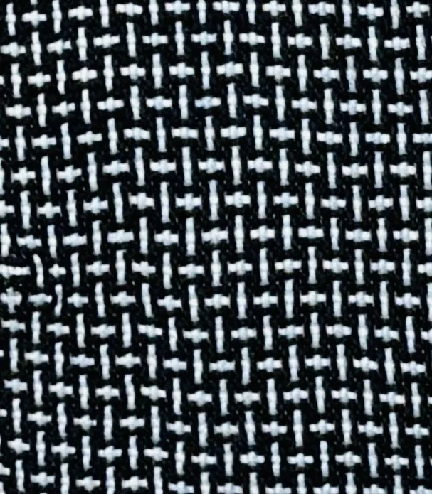 Close-up of black and white woven textile fabric with a geometric pattern.