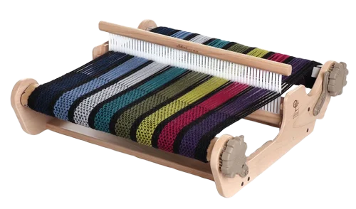 A Rigid Heddle weaving loom with colorful yarns in red, black, green, and blue.