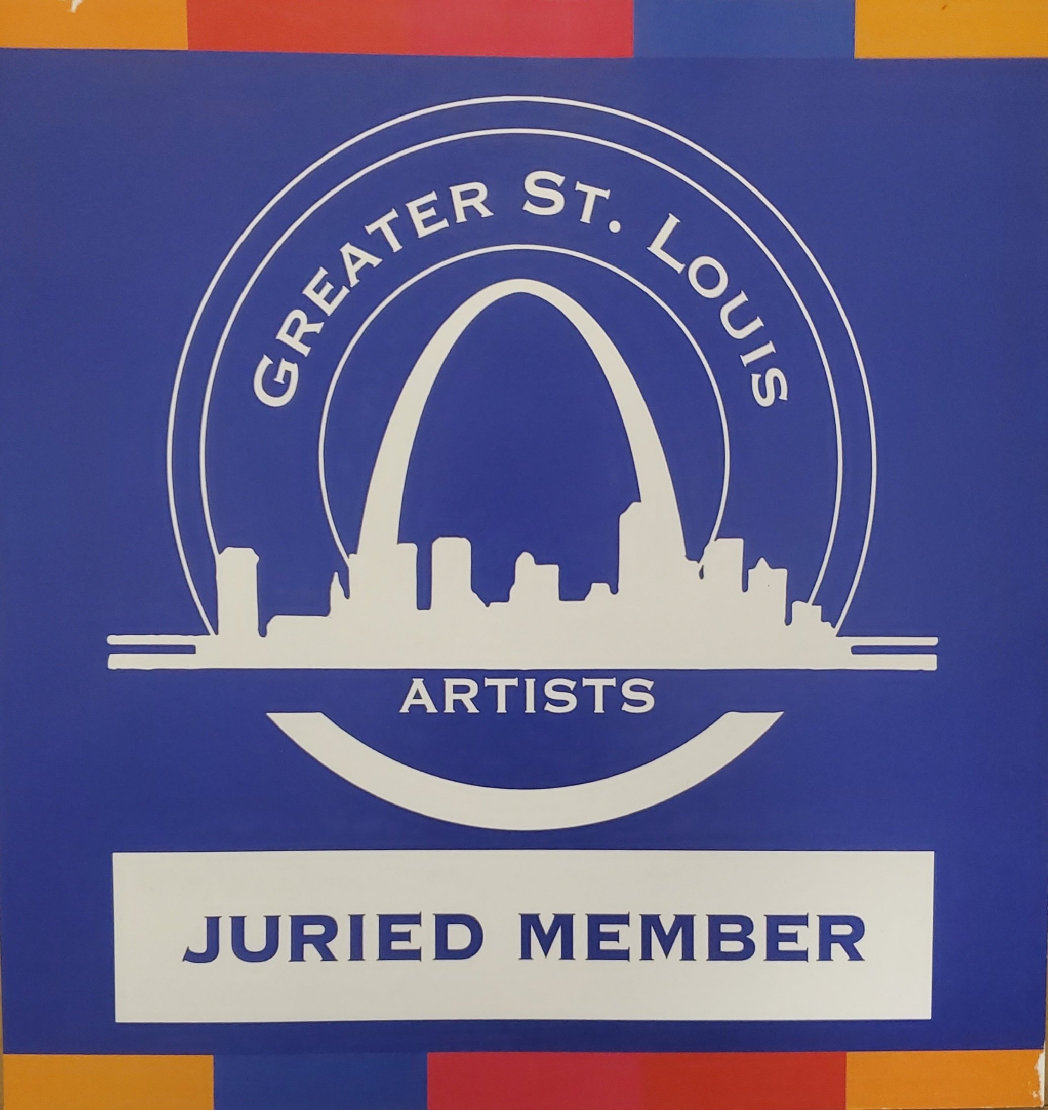 Blue sign with white outline of a skyline and the words 'GREATER ST. LOUIS' and 'ARTISTS' written on it. Below, a white section reads 'JURIED MEMBER' in blue letters.