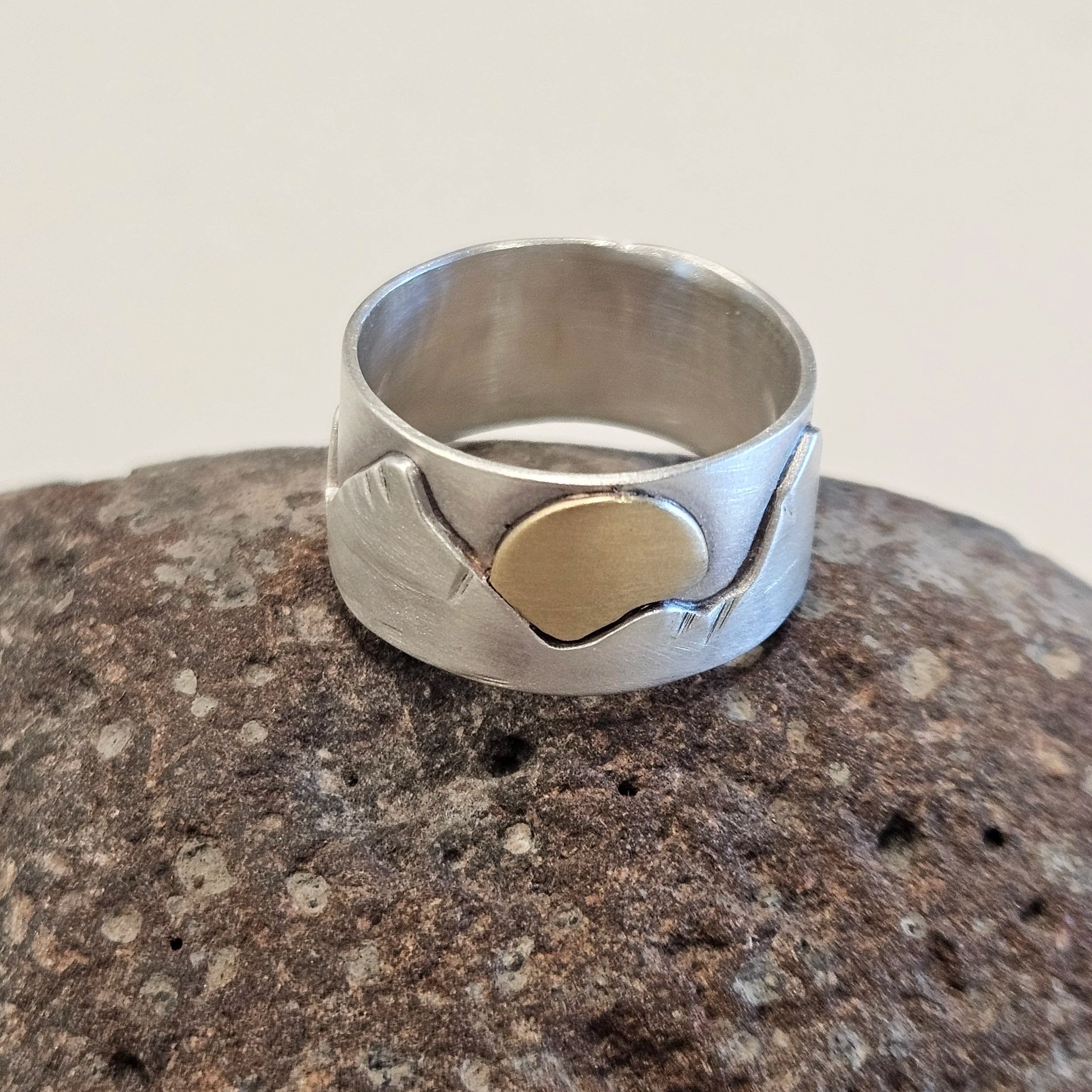 Sterling silver story teller ring with the sun rising up over the mountains. 