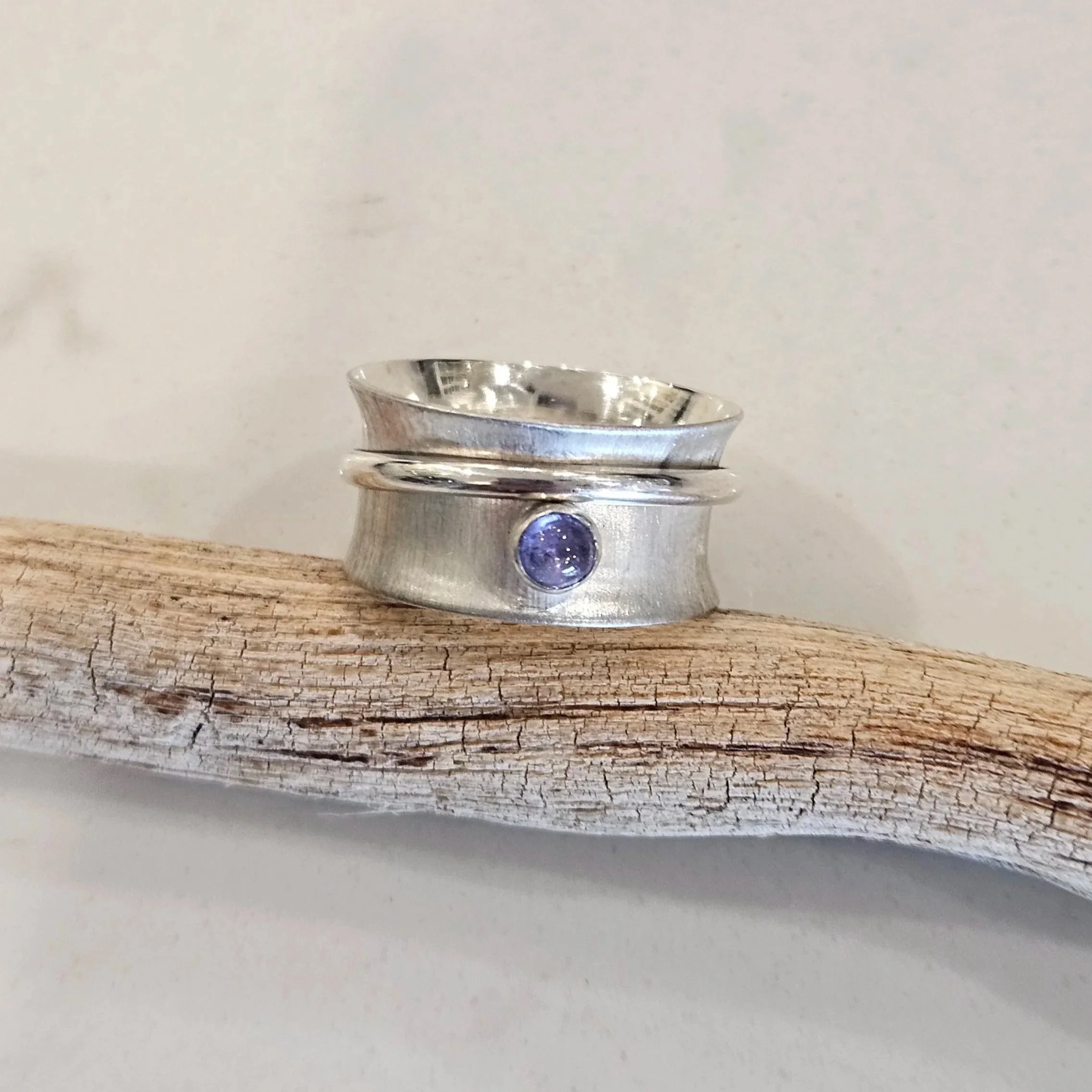 Sterling silver spinner ring with a Tanzanite stone.
