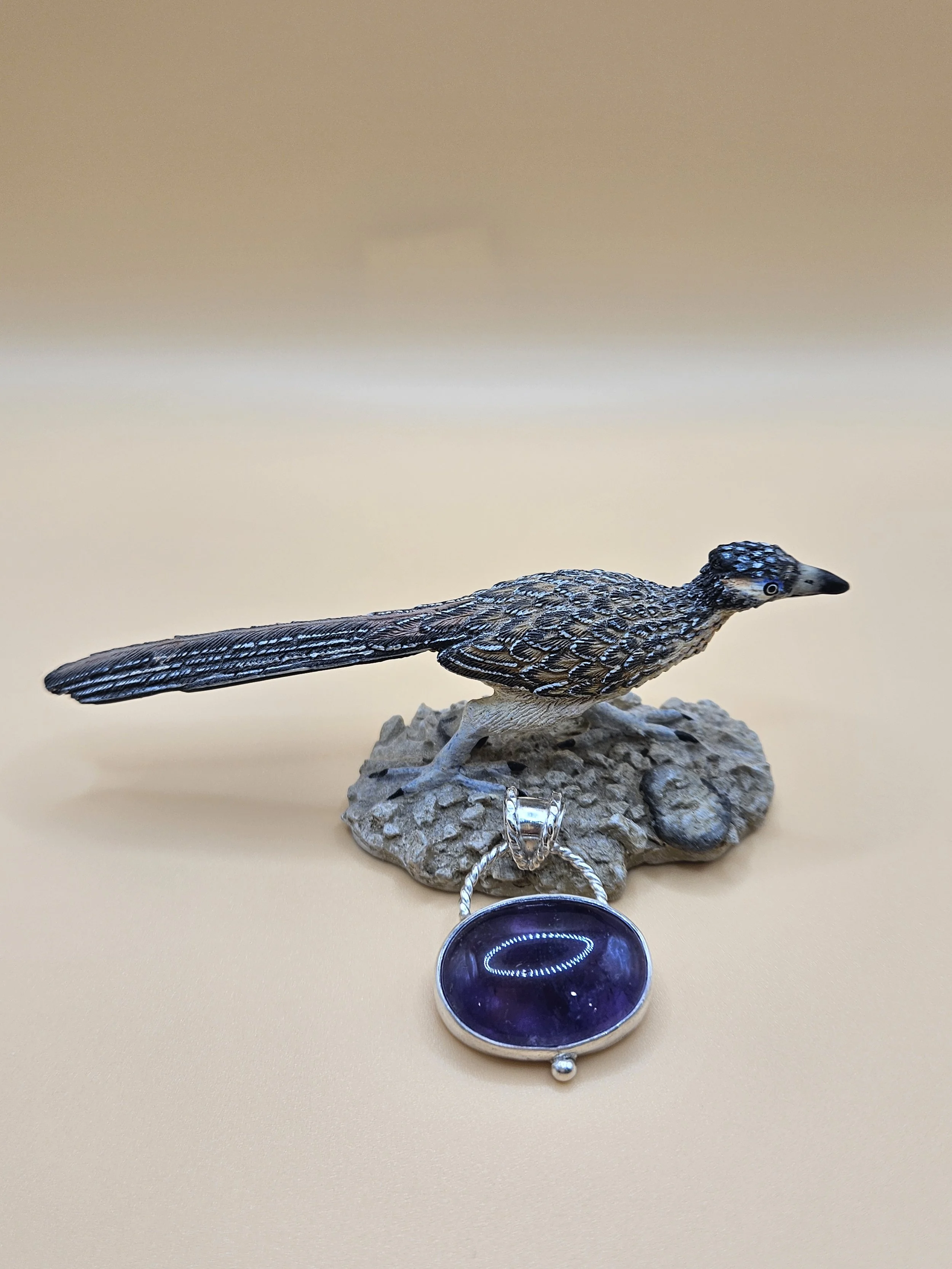 Sterling silver amethyst pendant with a rope trimmed bail and silver ball.