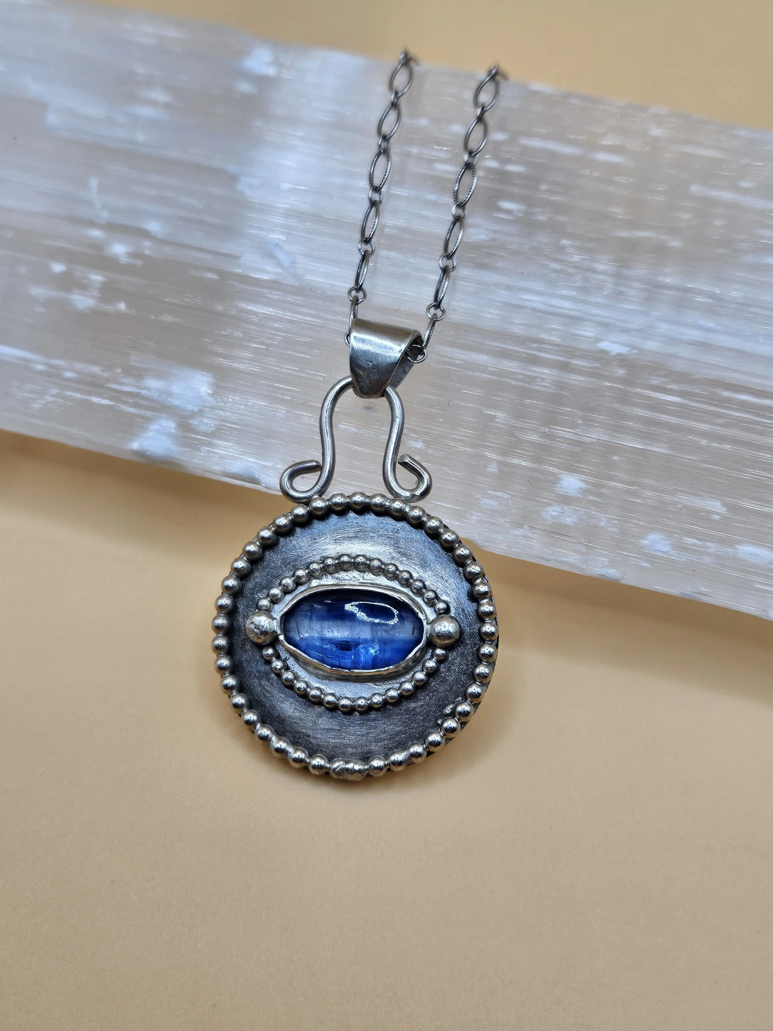 Sterling silver and kyanite stone "evil eye" pendant.