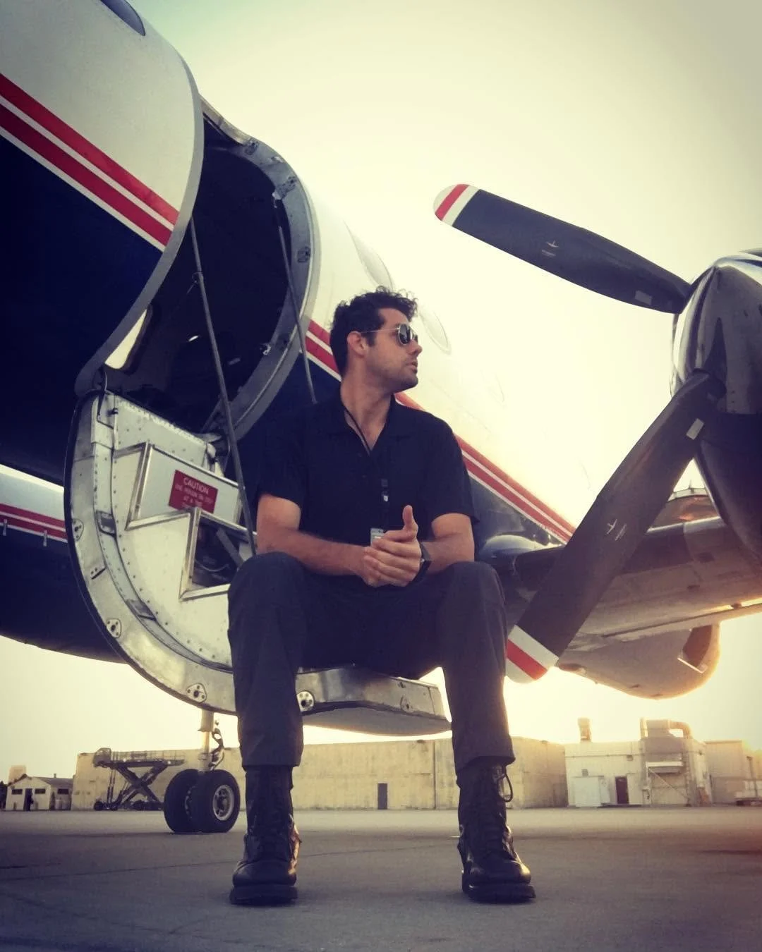 Yet another photo of Max Schwartz sitting on the door-steps of the reliable "Metro-Liner" (SA-227.) Picture taken at sunset. These aircraft were / are known as work-horses in the aviation industry.