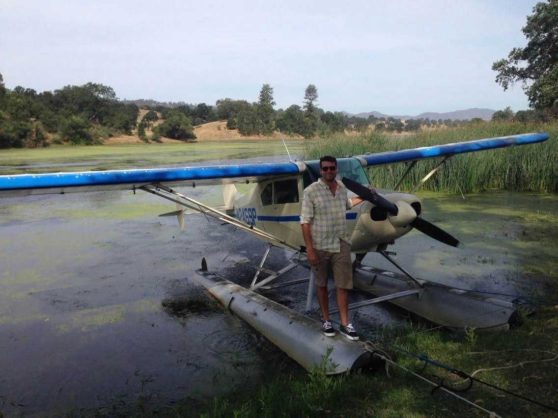 Man Schwartz standing on the float of a Single-Engine seaplane, a piper Tri-Pacer. This was taken in northern California, near Calaveras Seaplane Base. This was roughly taken in 2015. This was where Max earned his Single-Engine Seaplane rating.