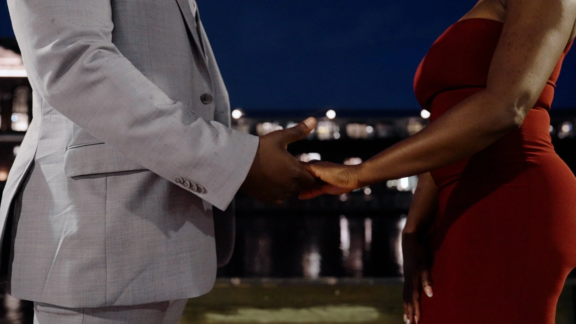 Moyo and Liam holding hands during their engagement shoot.