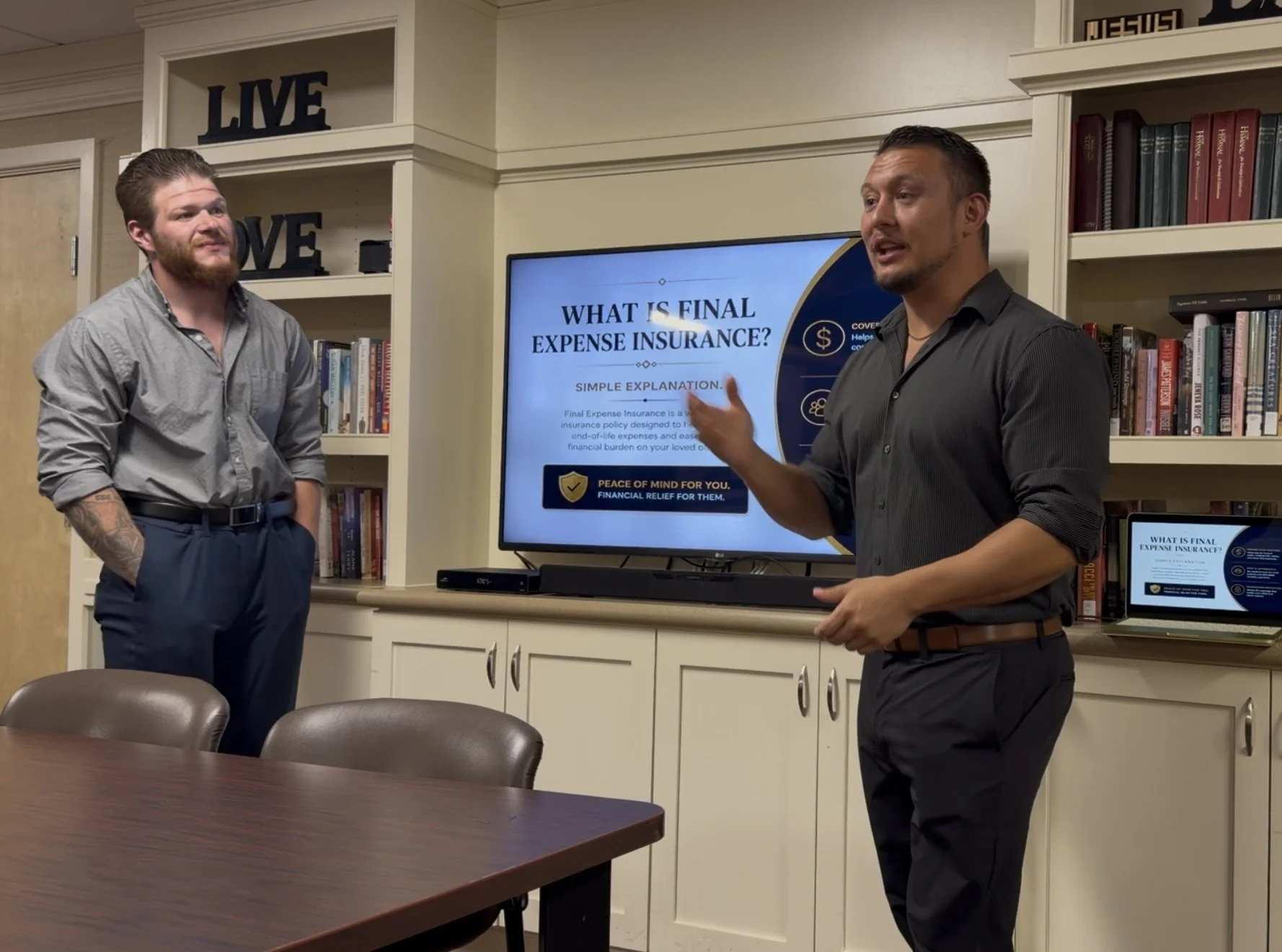 Travis Abner presenting while Matt Conley looks on during a senior education presentation.