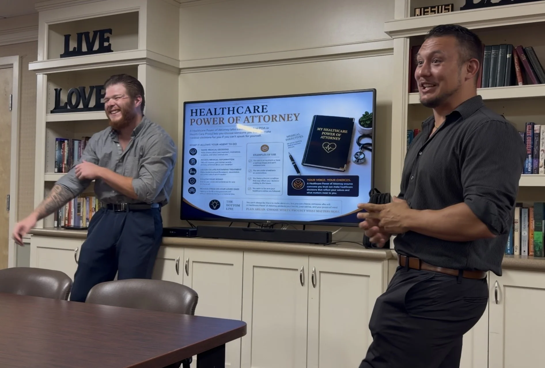 Matt Conley and Travis Abner smiling during a senior education presentation.