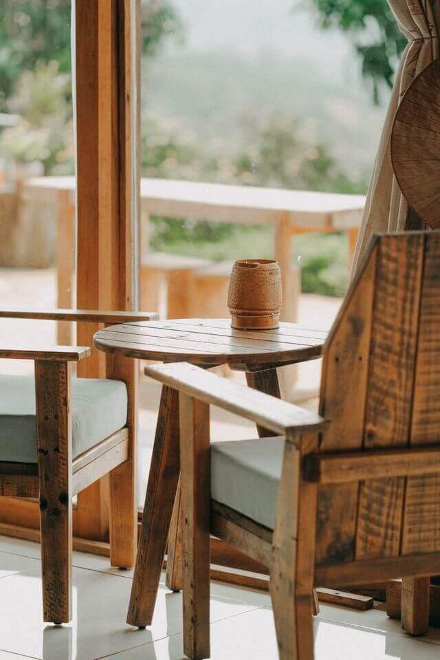 Two warm wooden chairs and a small table by a window, inviting a conversation about workforce continuity in care organizations.