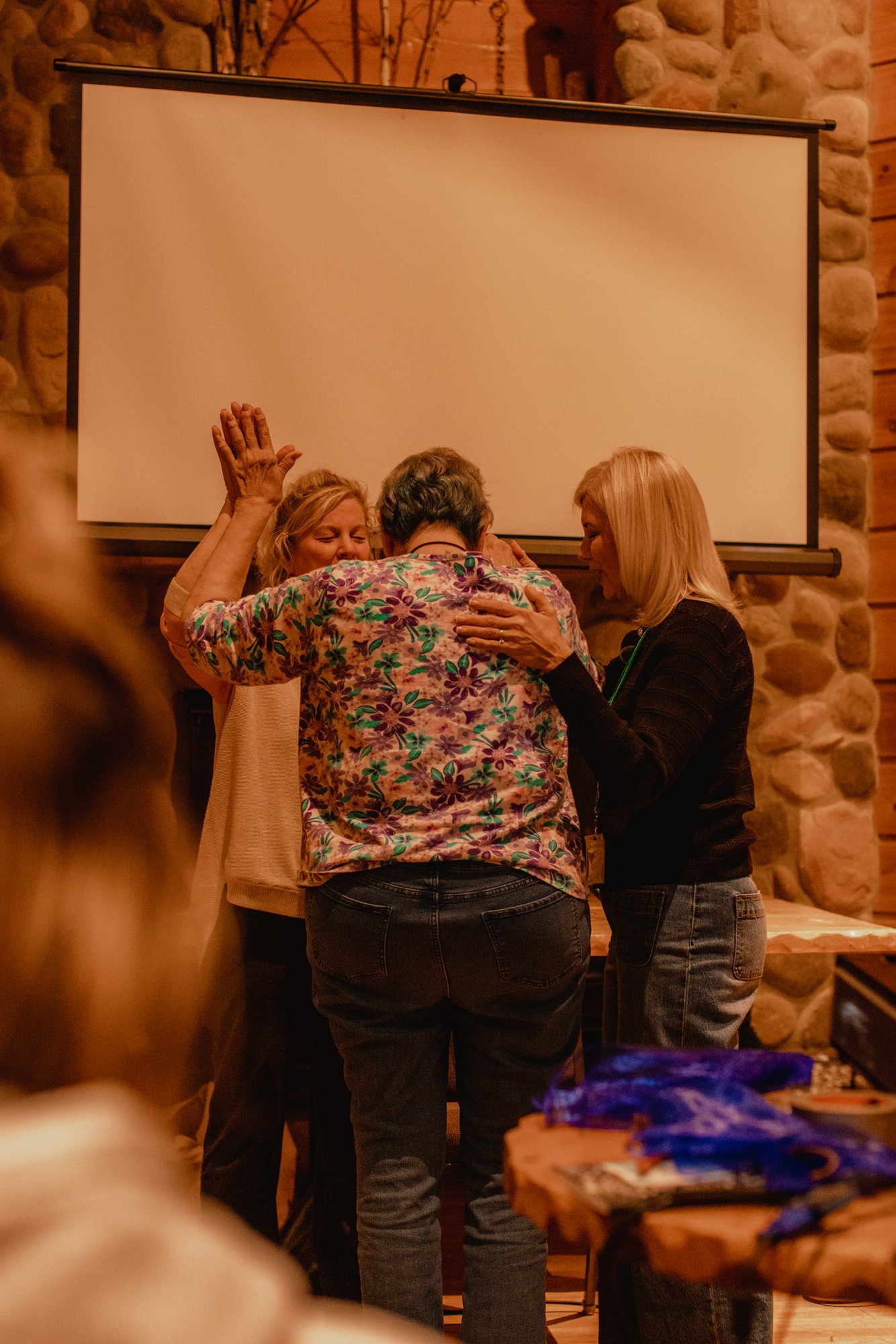 Bobbi Quiggle praying for women at a retreat