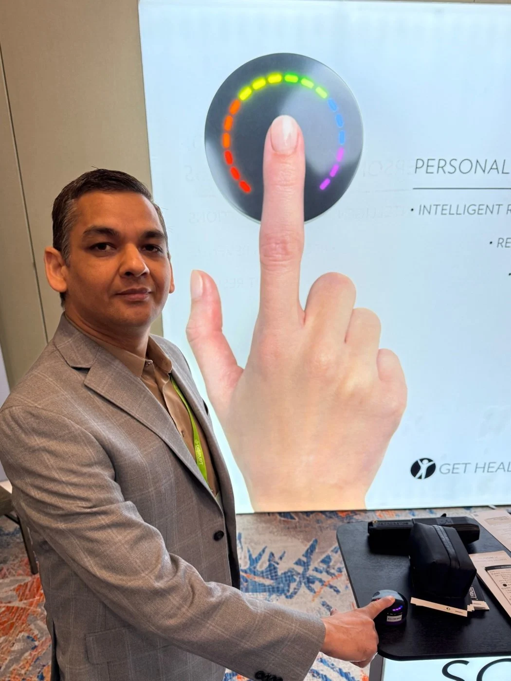 Person using the Nu Skin ageLOC PRYSM device for a non-invasive nutritional wellness assessment measuring antioxidant status.