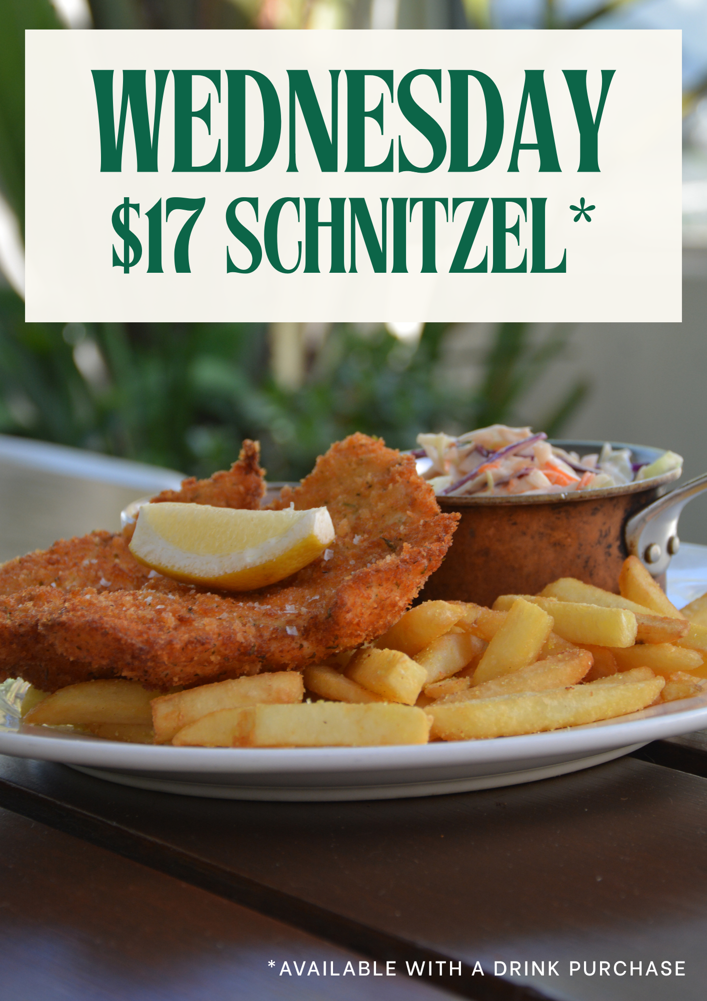 Sign advertising Wednesday $17 schnitzel special with a background image of a plate of fried schnitzel with lemon, French fries, and coleslaw, along with a small dish of sauce, all set on a dark wooden table.