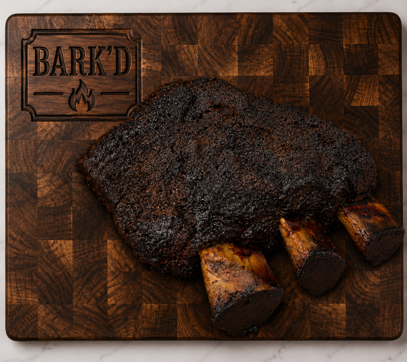 A smoked beef brisket with a dark bark resting on a wooden cutting board with a BARK'D logo and flame engraving.