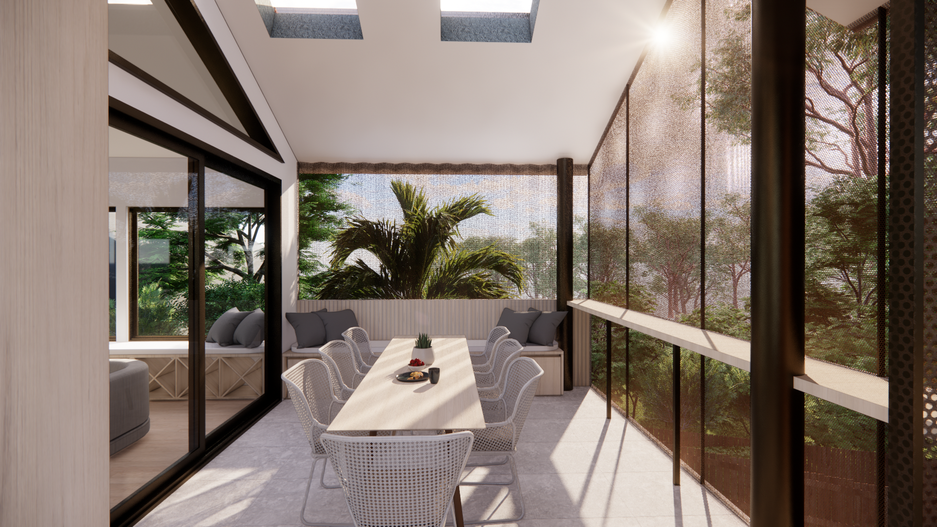 A bright enclosed balcony with large windows and mesh screens showing trees outside. There is a long dining table with white chairs, a small plant, and some food and drinks on it. The space has a modern and airy design with natural sunlight streaming in.
