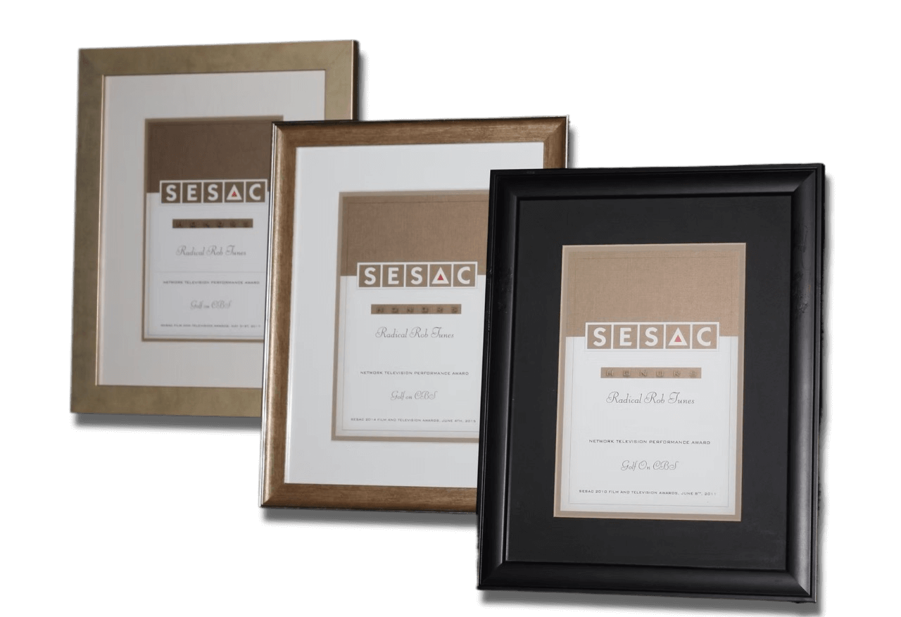 Three framed awards with different colored borders and a black background.
