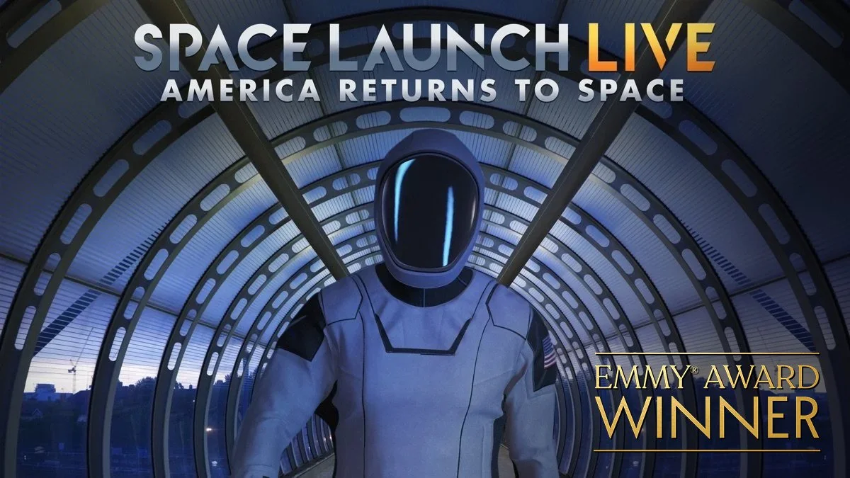 A futuristic astronaut in a space suit standing in a tunnel with a curved ceiling, celebrating a win at the Emmy Awards with the text "Space Launch Live: America Returns to Space" and "Emmy Award Winner".