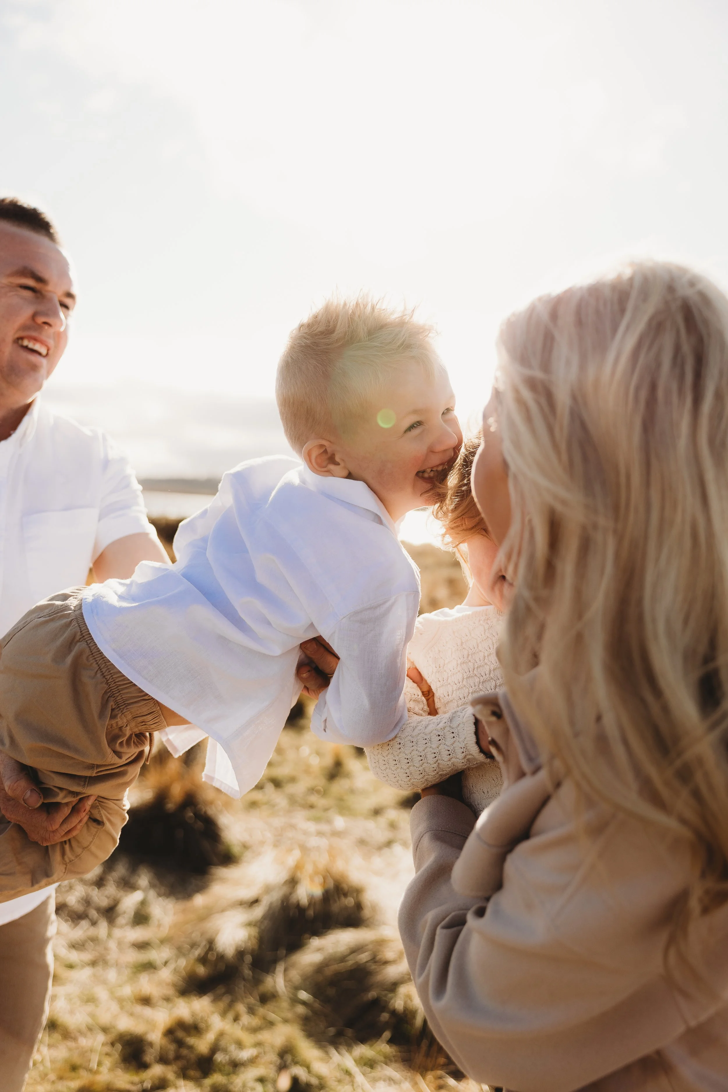 family playing in the golden sunlight