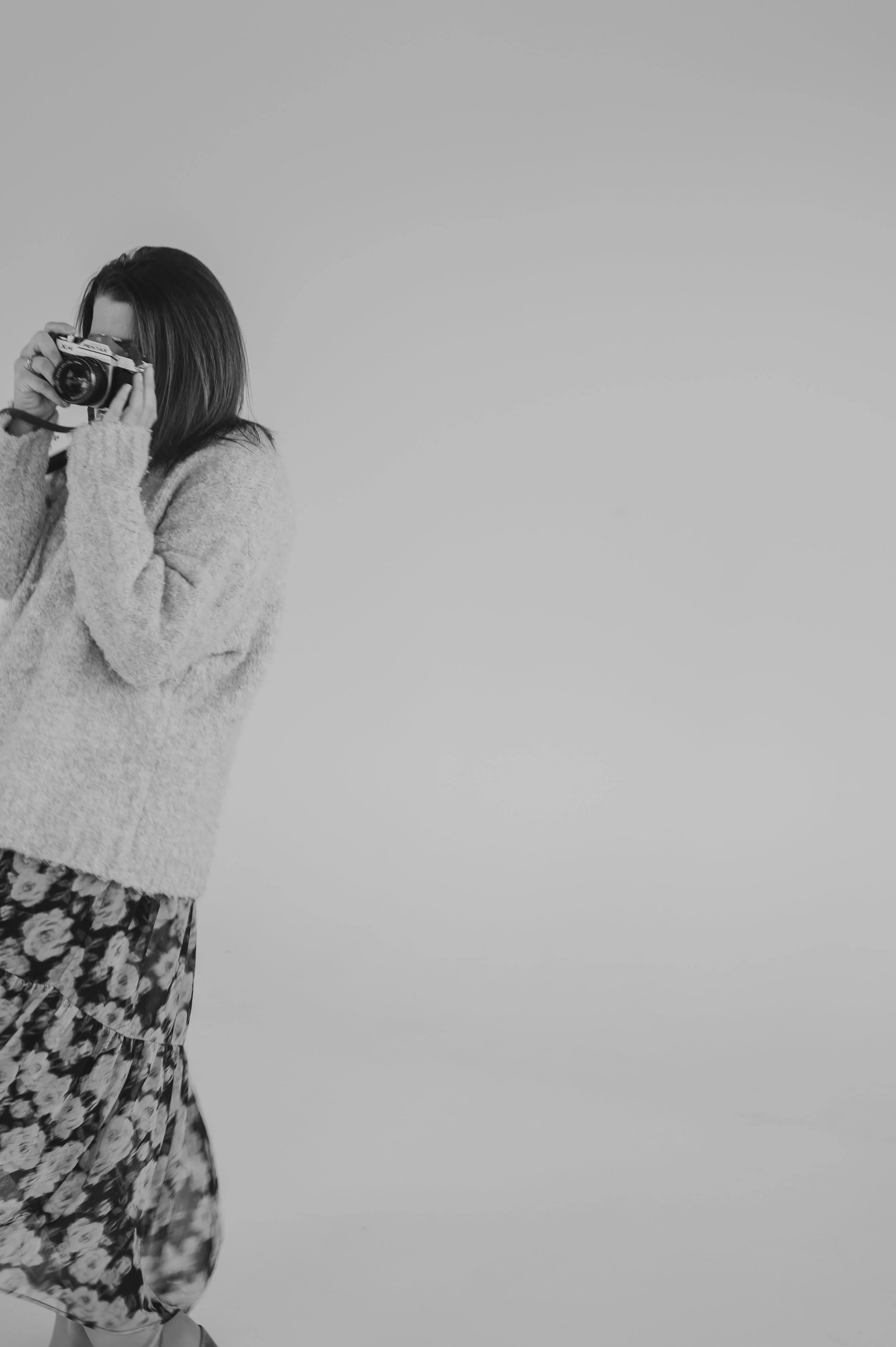 Photographer holding camera and taking photo
