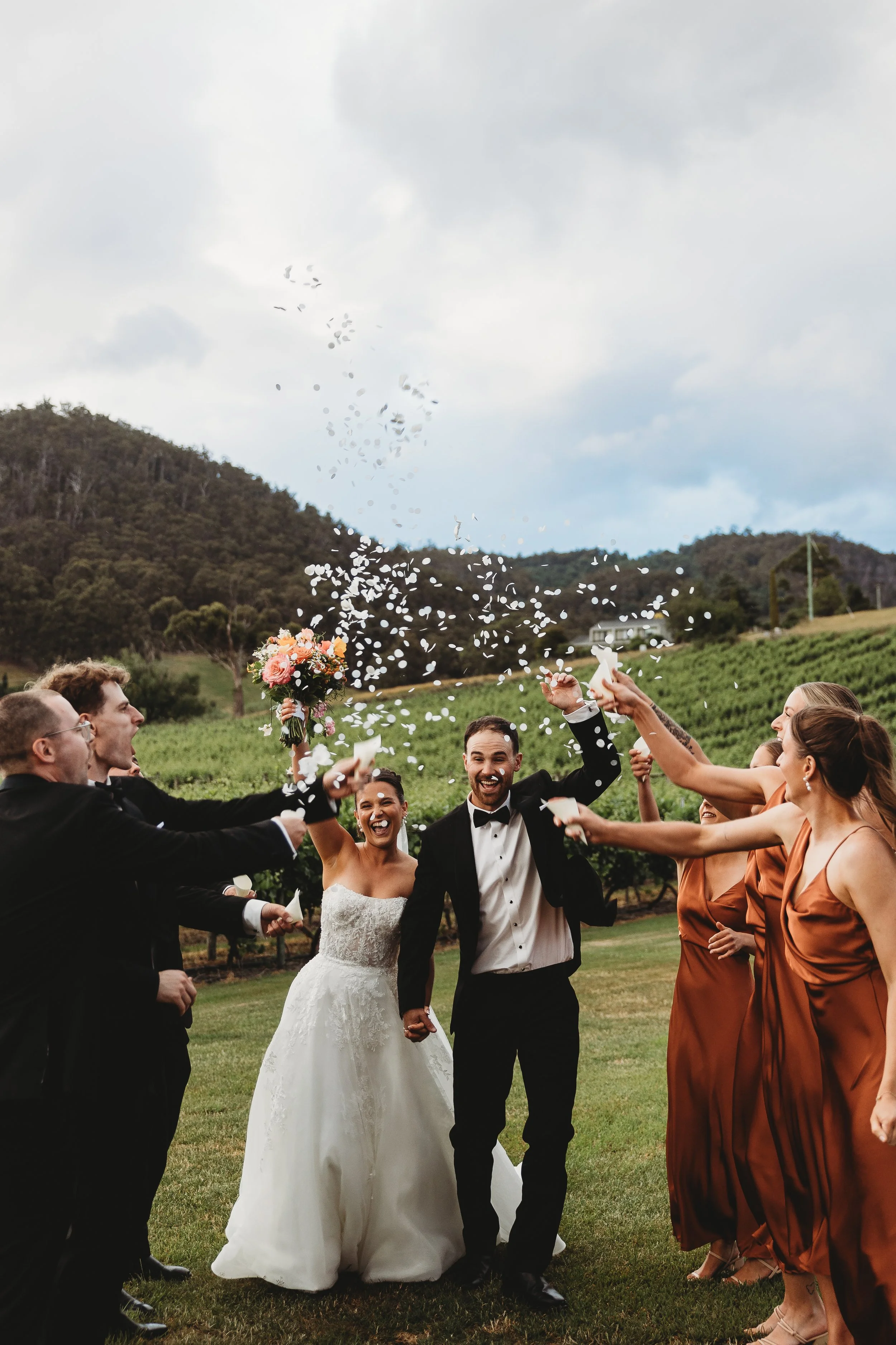 Bride and groom walking through the isle with confetti