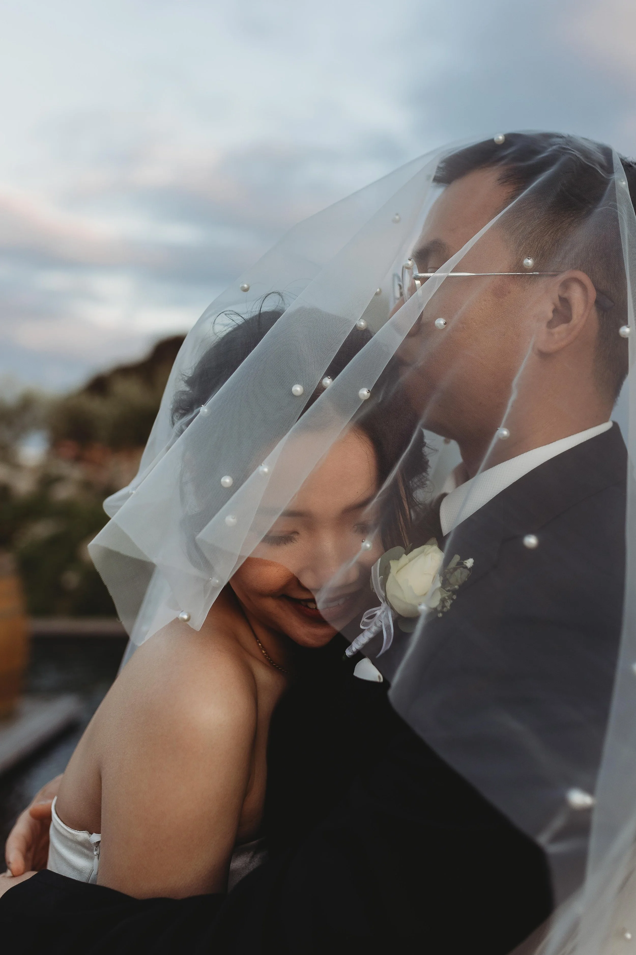 Husband and wife embracing on wedding day 