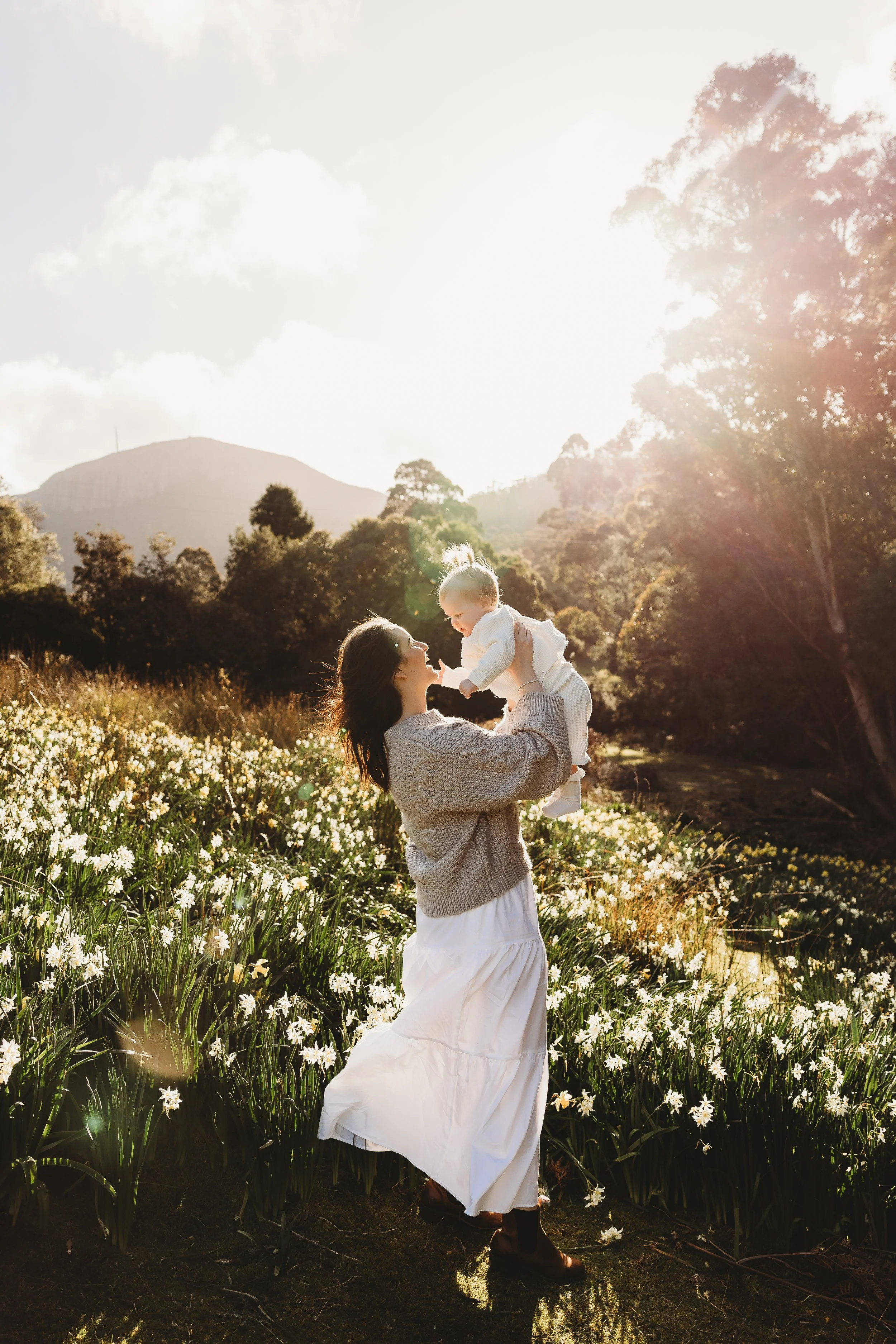Mum and Baby ina  field of daffodils in the golden light