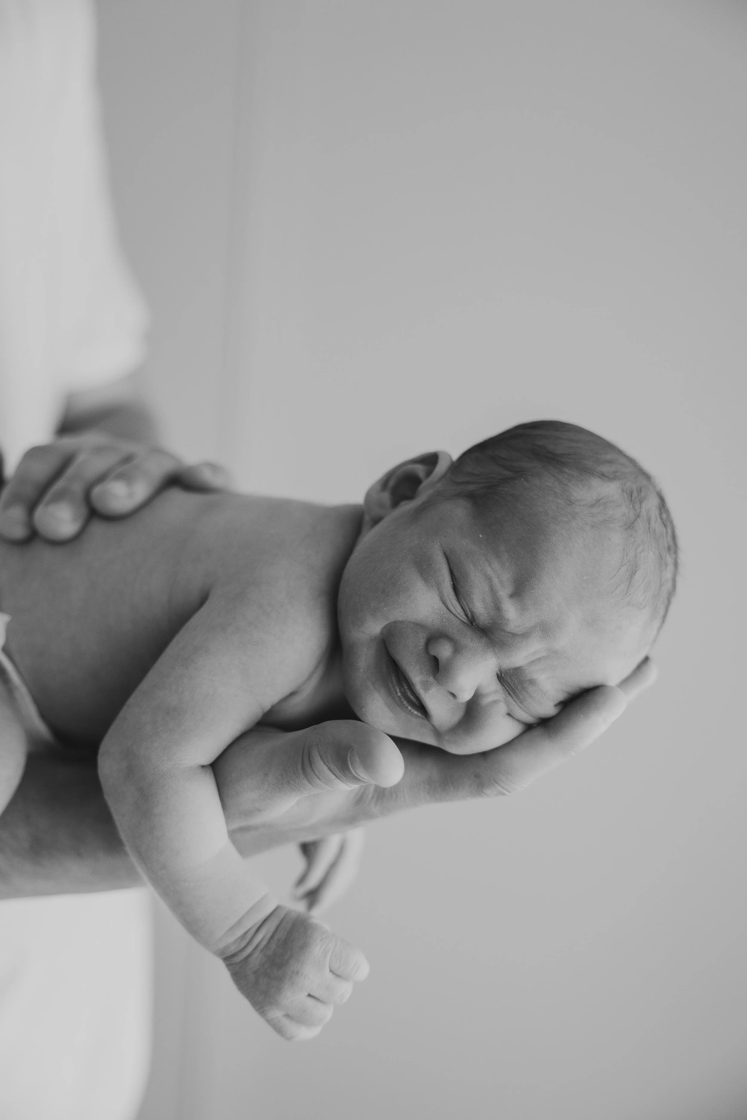 baby in dads arm