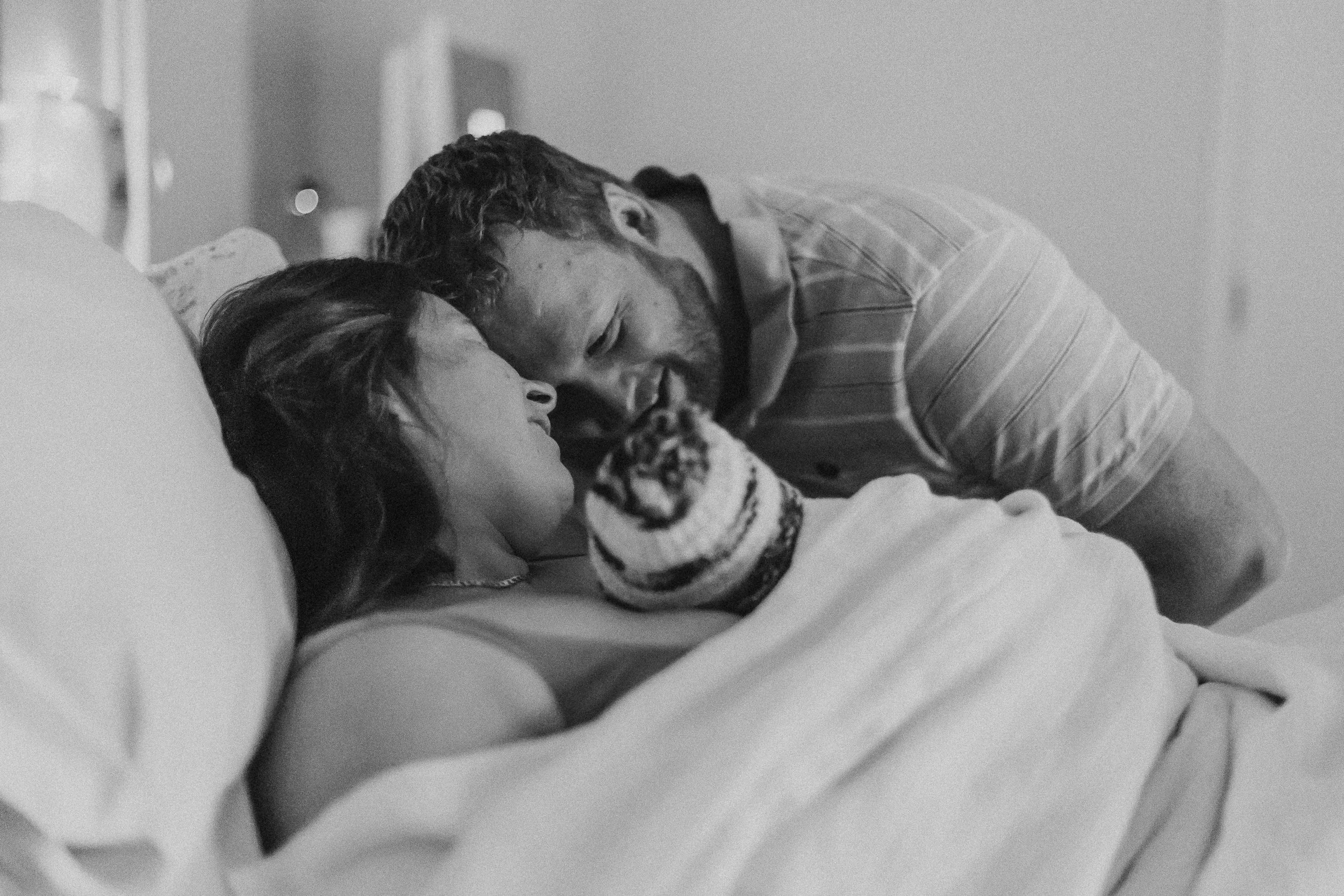 Birth photography mum and dad admiring new baby