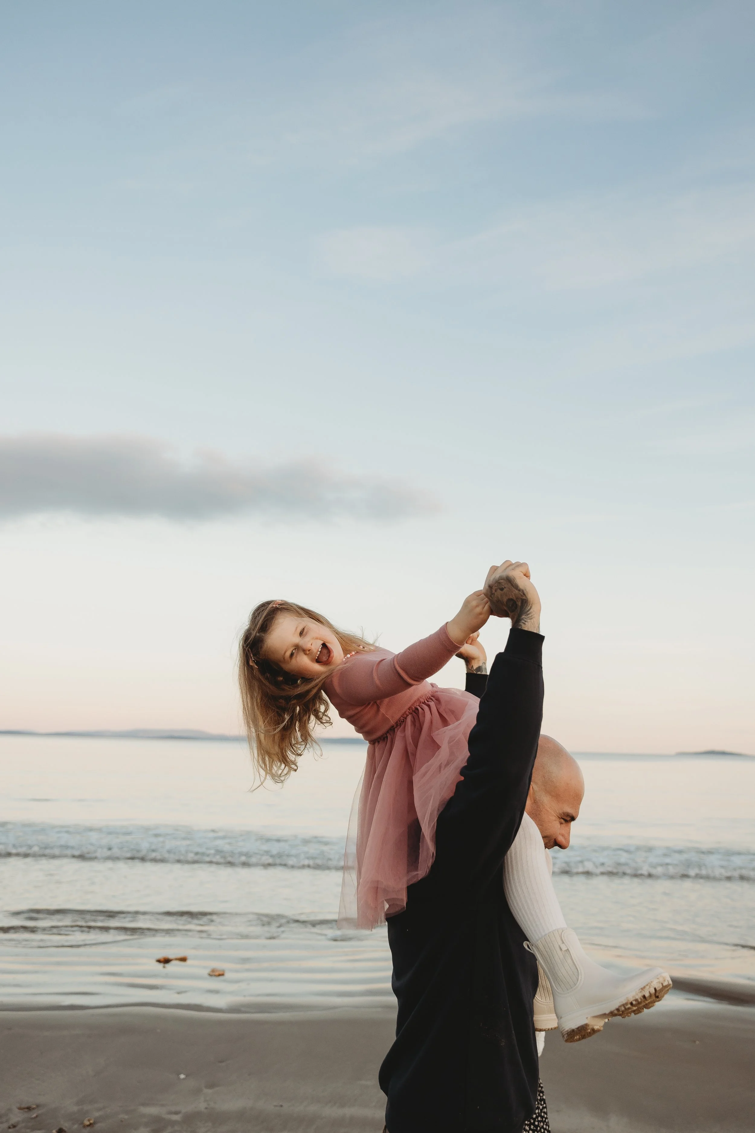 Father and daughter on beach having a shoulder ride