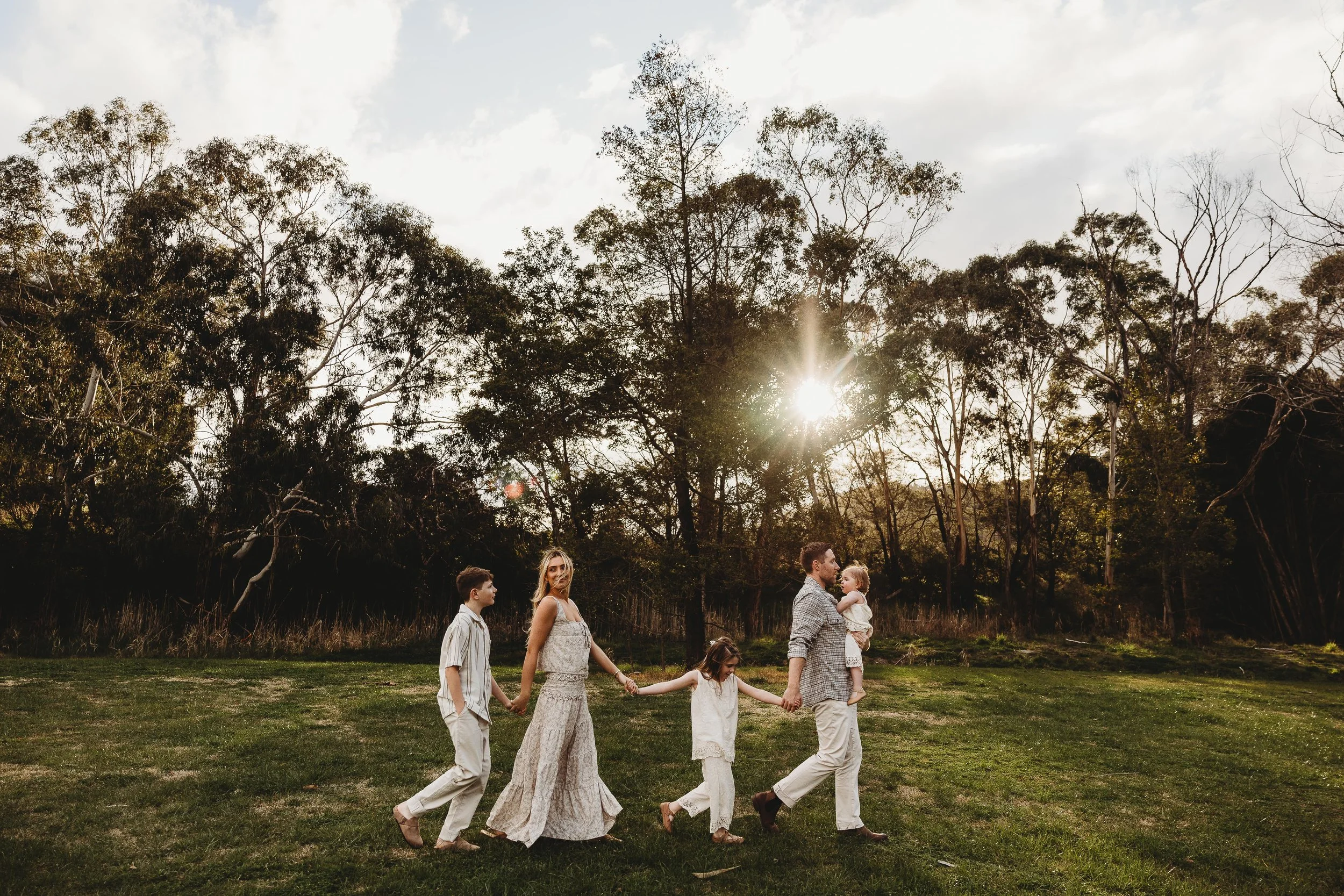 family walking along holding hands