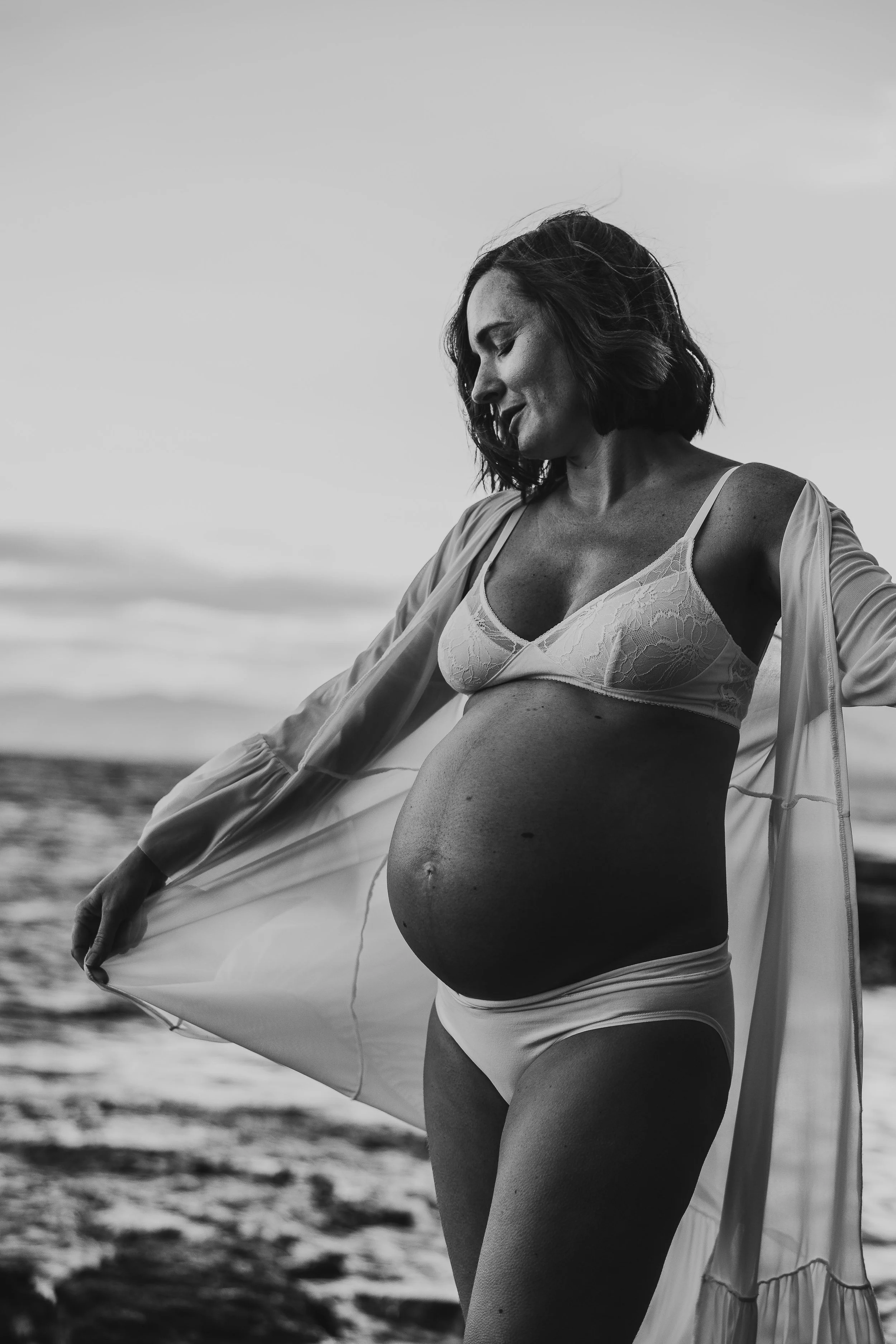 Mother embracing her pregnant belly - baby bump