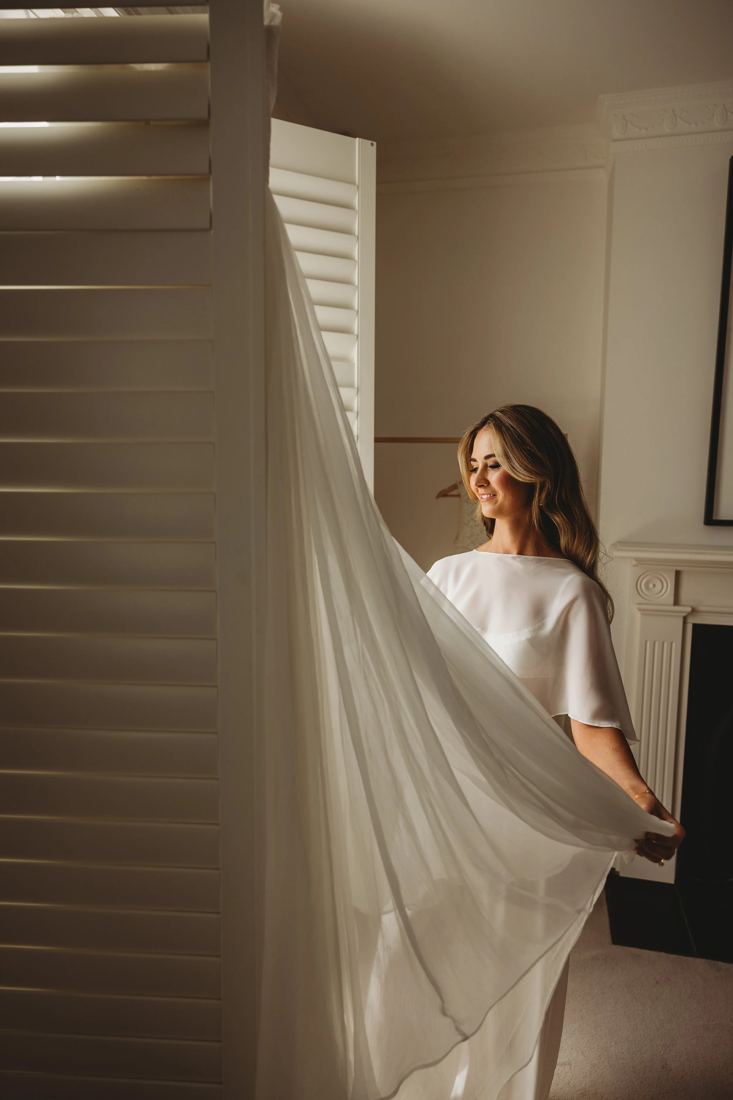 bride looking at wedding dress on wedding day