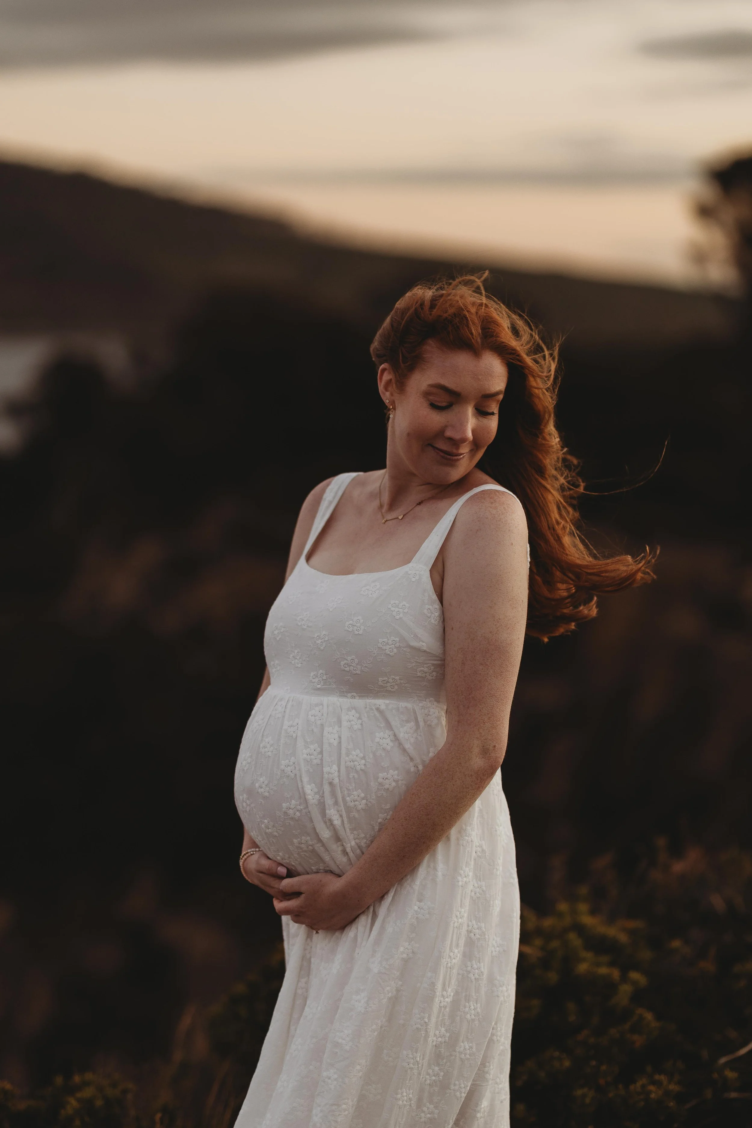 pregnant mum to be embracing her baby belly