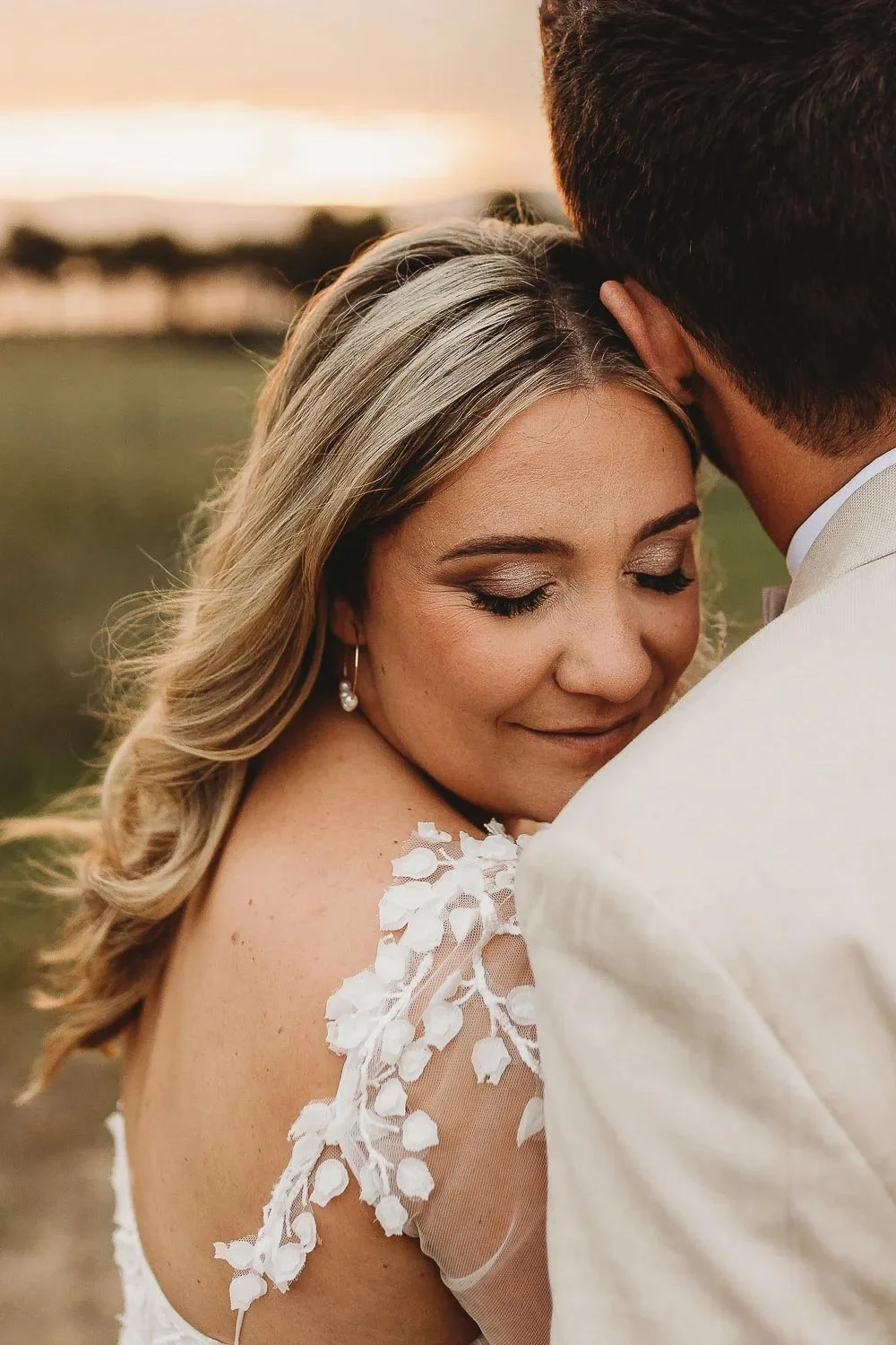 Bride snuggled into grooms shoulder