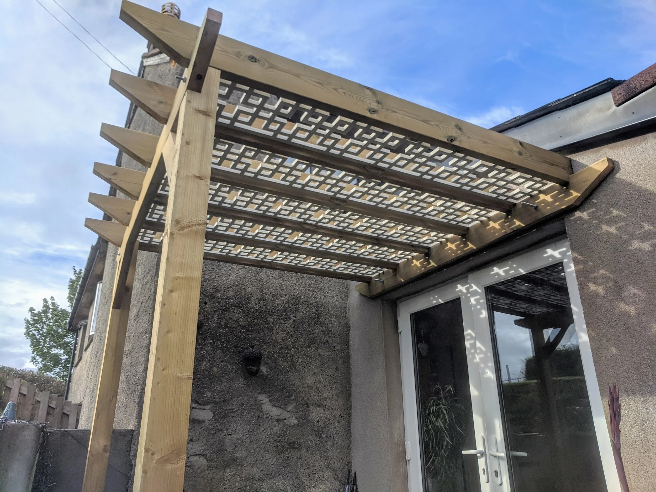 Wooden pergola structure attached with lattice panels