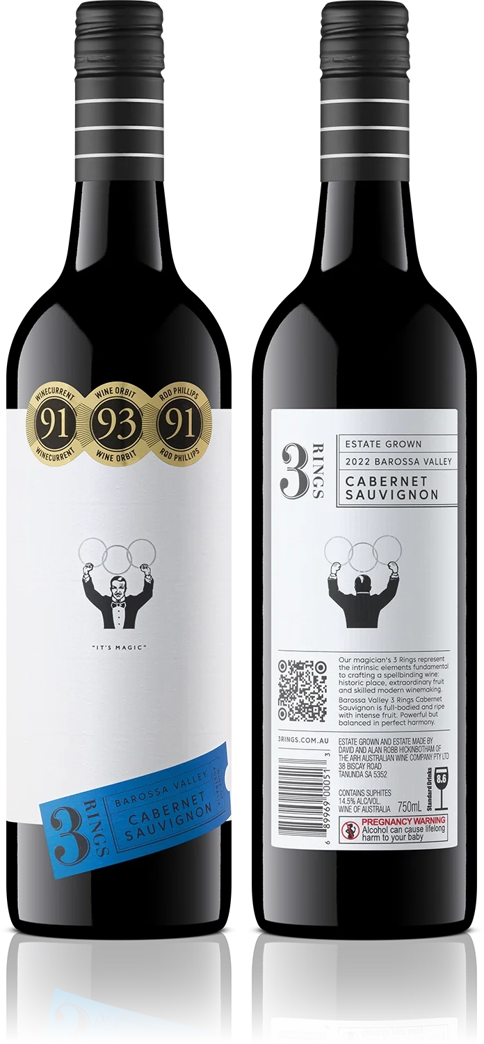 Two bottles of Cabernet Sauvignon wine from Barossa Valley, Australia, with labels featuring awards, a picture of a magician, and a blue branding label for 3 Rings.