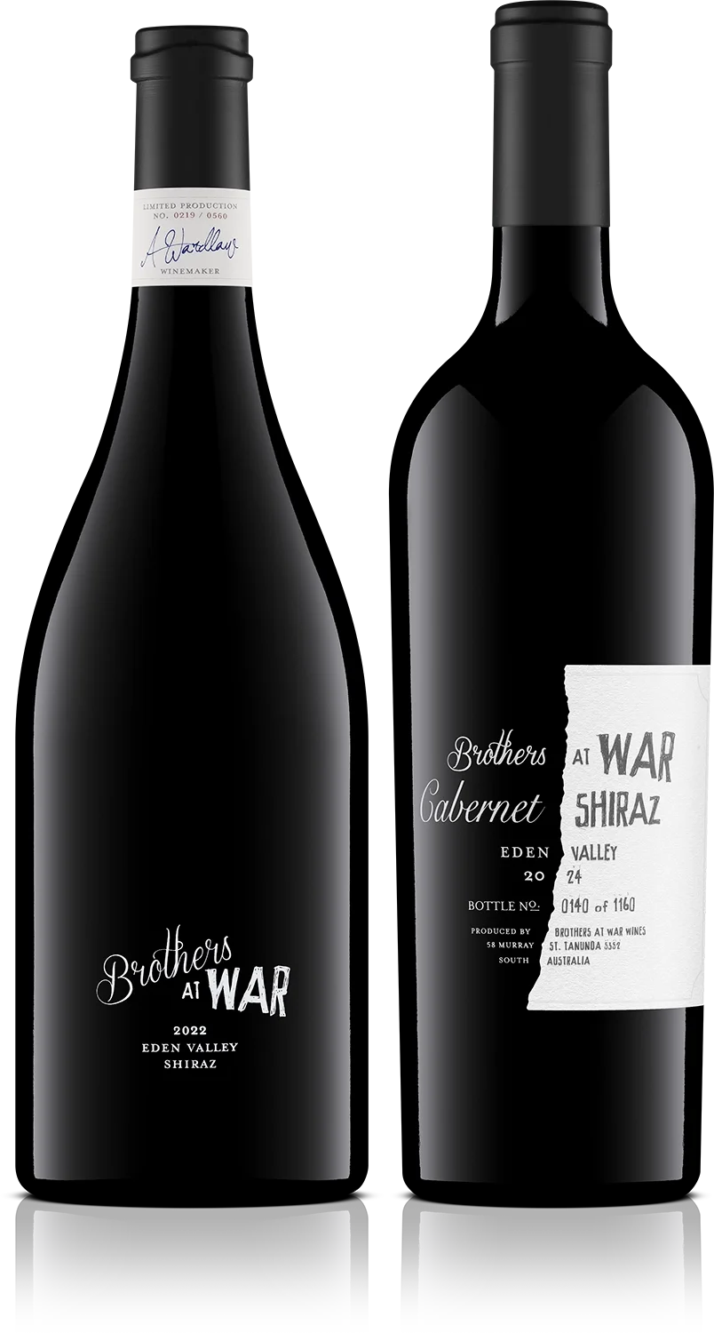 Two black wine bottles with modern labels, one with a white band around the neck and the other with an attached white paper tag, both labeled 'Brothers at War' and 'Cabernet' with additional details.
