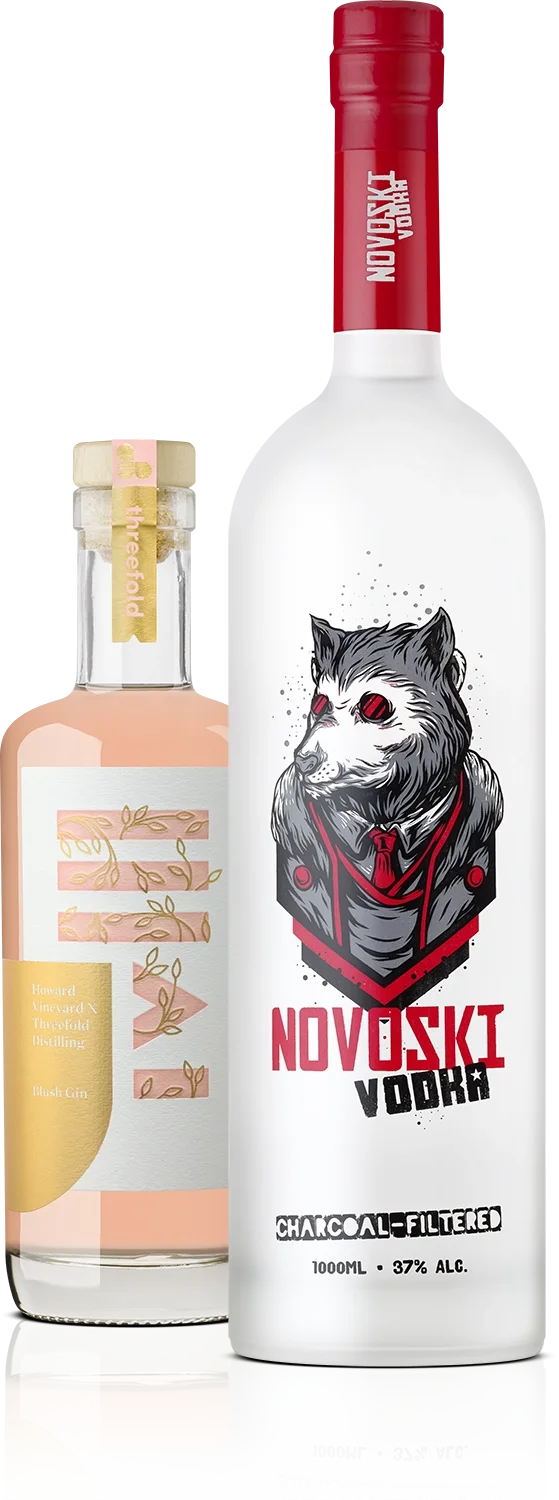 A bottle of Novoski vodka with a wolf logo on the label and a bottle of Threefold pink gin with a bamboo-themed label.