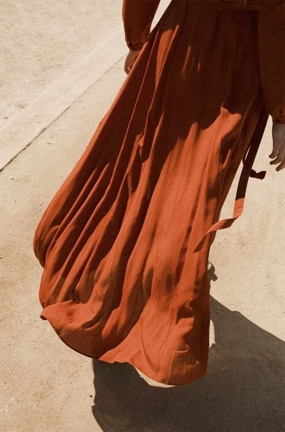 Close-up of a flowing burnt-orange dress in motion  connect with Maartje Wammes on LinkedIn