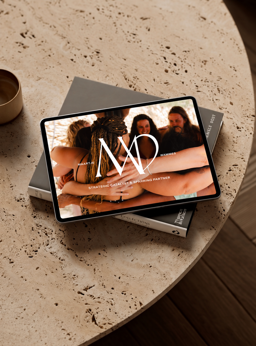 Tablet on a travertine table showing the Strategic Partnership with Maartje Wammes