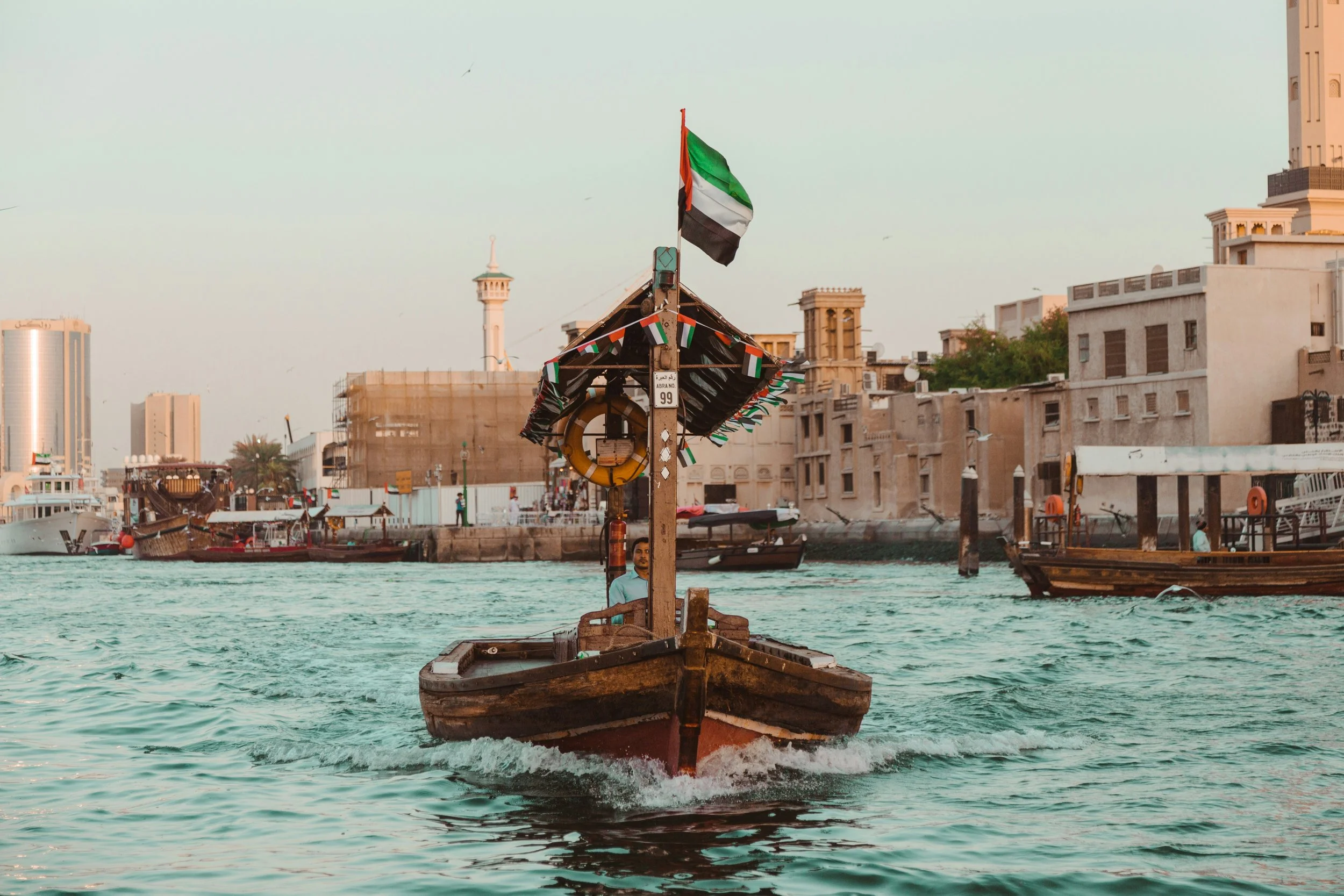 Traditional UAE Abra boat navigating waters, symbolizing expert corporate structuring and strategic establishmenet across ADGM, DIFC, and Mainland UAE.