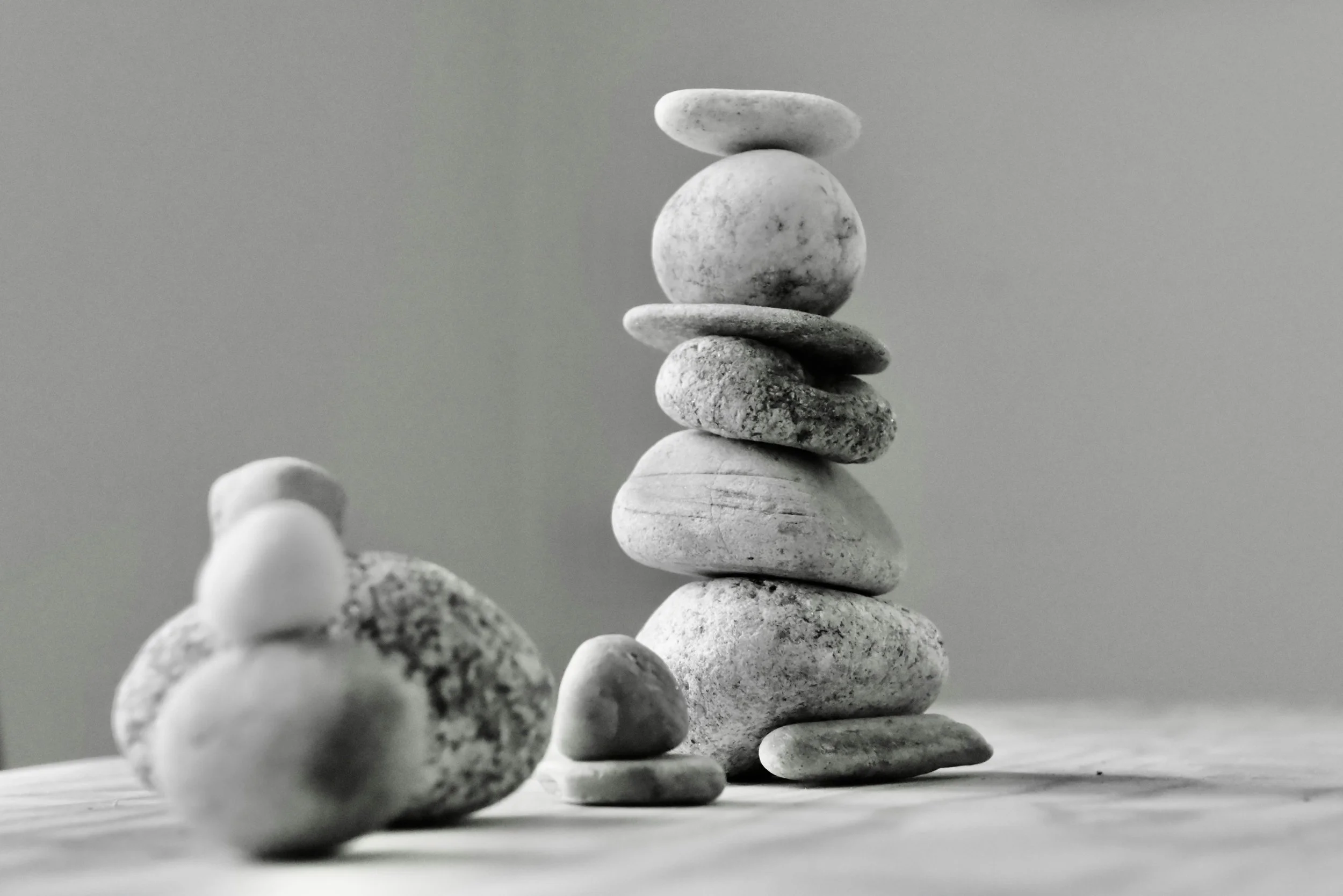Balanced stones symbolizing legal stability, governance, and the transparent English common law system of the Dubai International Financial Centre (DIFC).