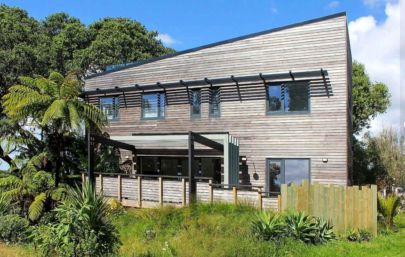 Adams Building architectural home with timber cladding, angular roofline and outdoor deck in Fitzroy, New Plymouth.