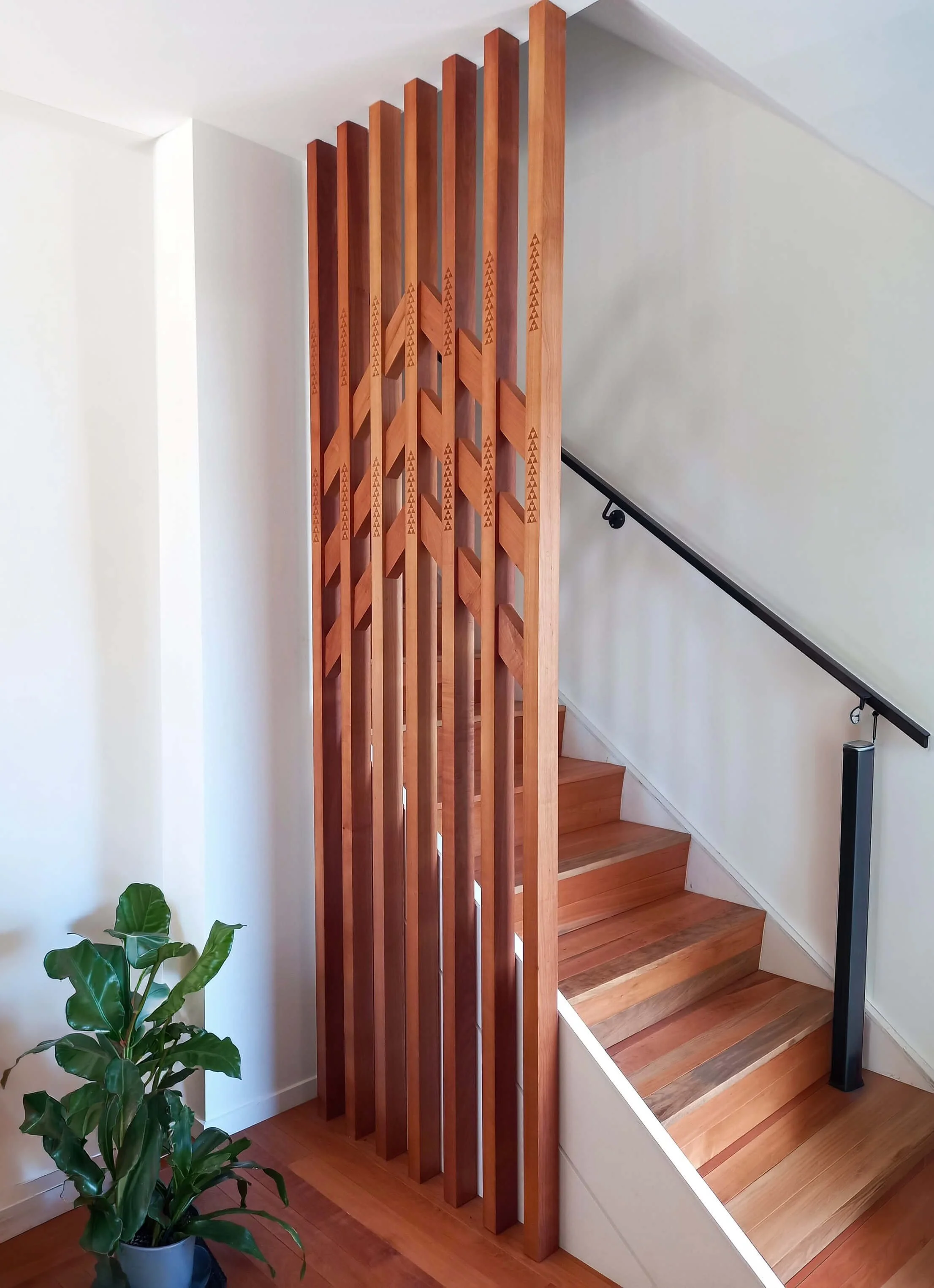 Adams Building custom timber staircase with decorative timber screen and black handrail in New Plymouth, Taranaki.