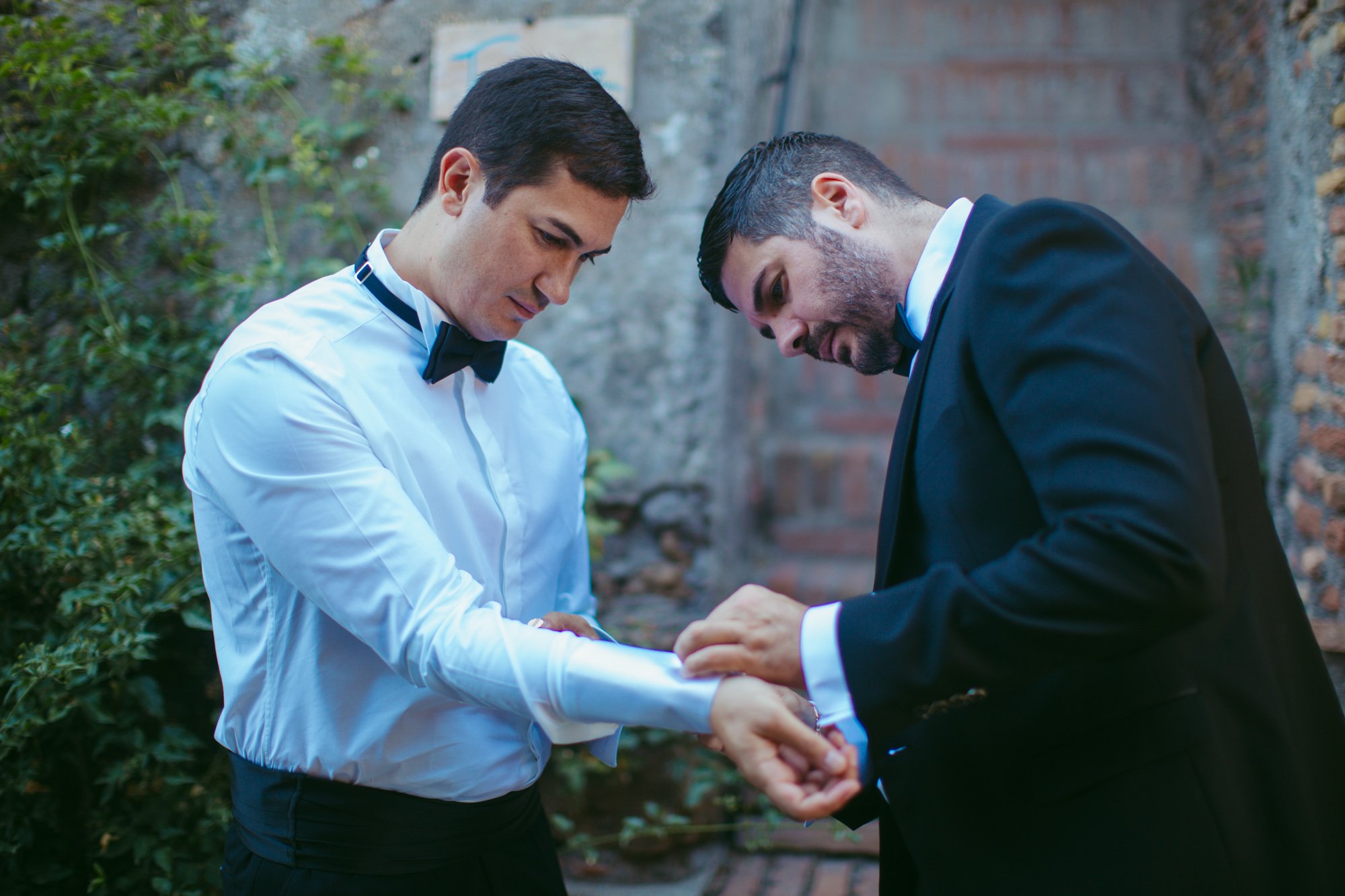 Il testimone aiuta lo sposo a chiudere i gemelli della camicia prima delle nozze
