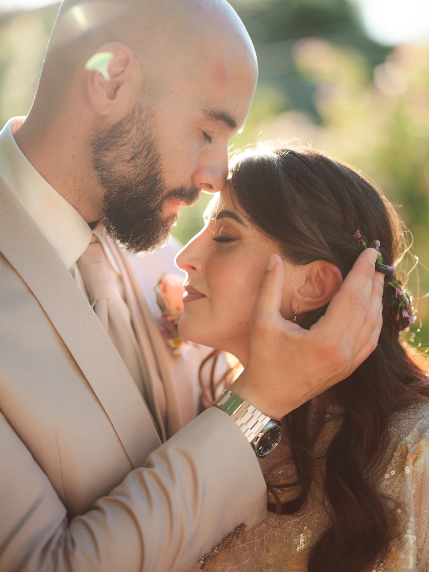 Sposo che appoggia dolcemente la fronte su quella della sposa tenendole la testa con la mano
