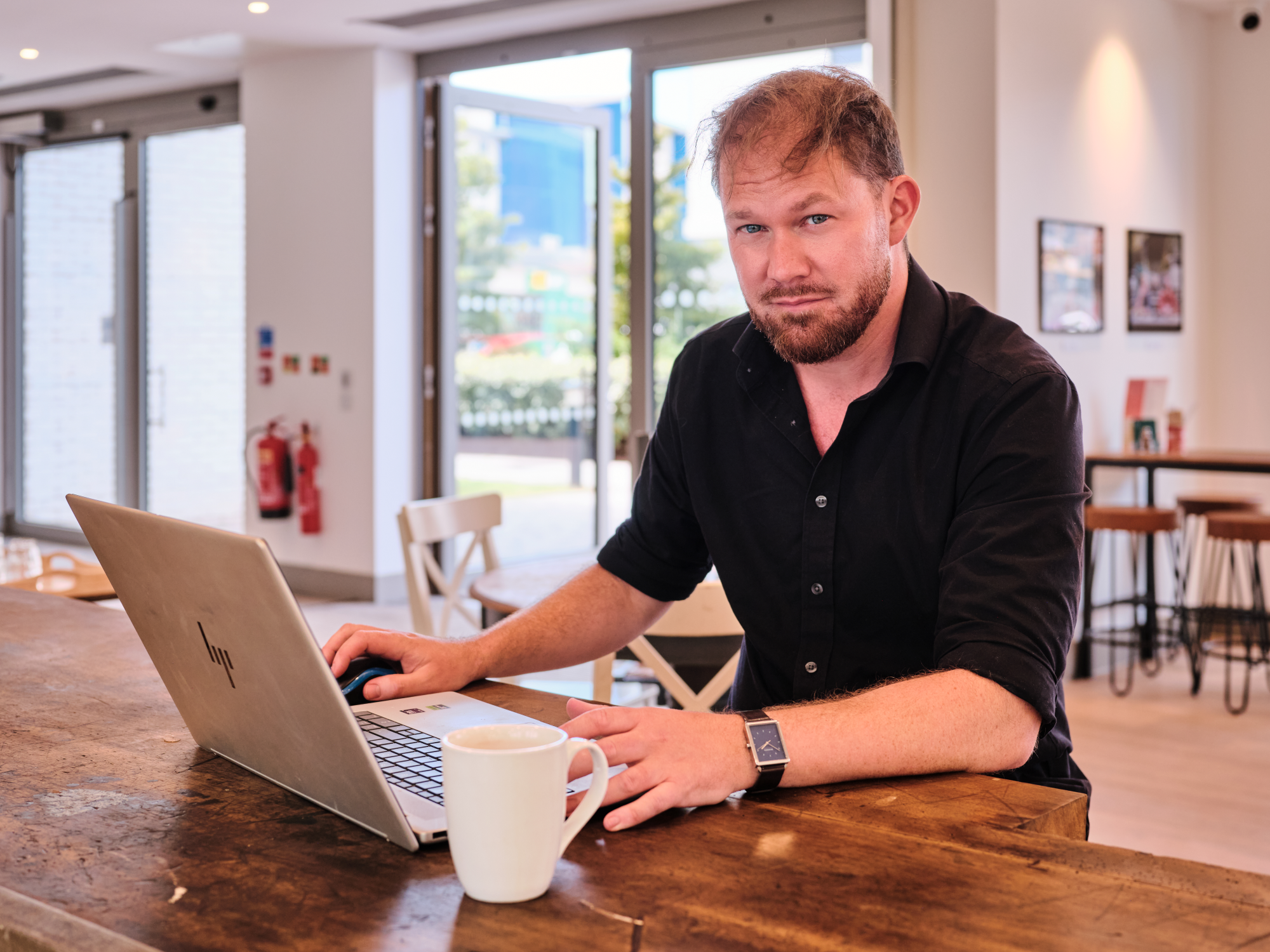 The Legacy Expert working on a laptop computer with a mug of tea