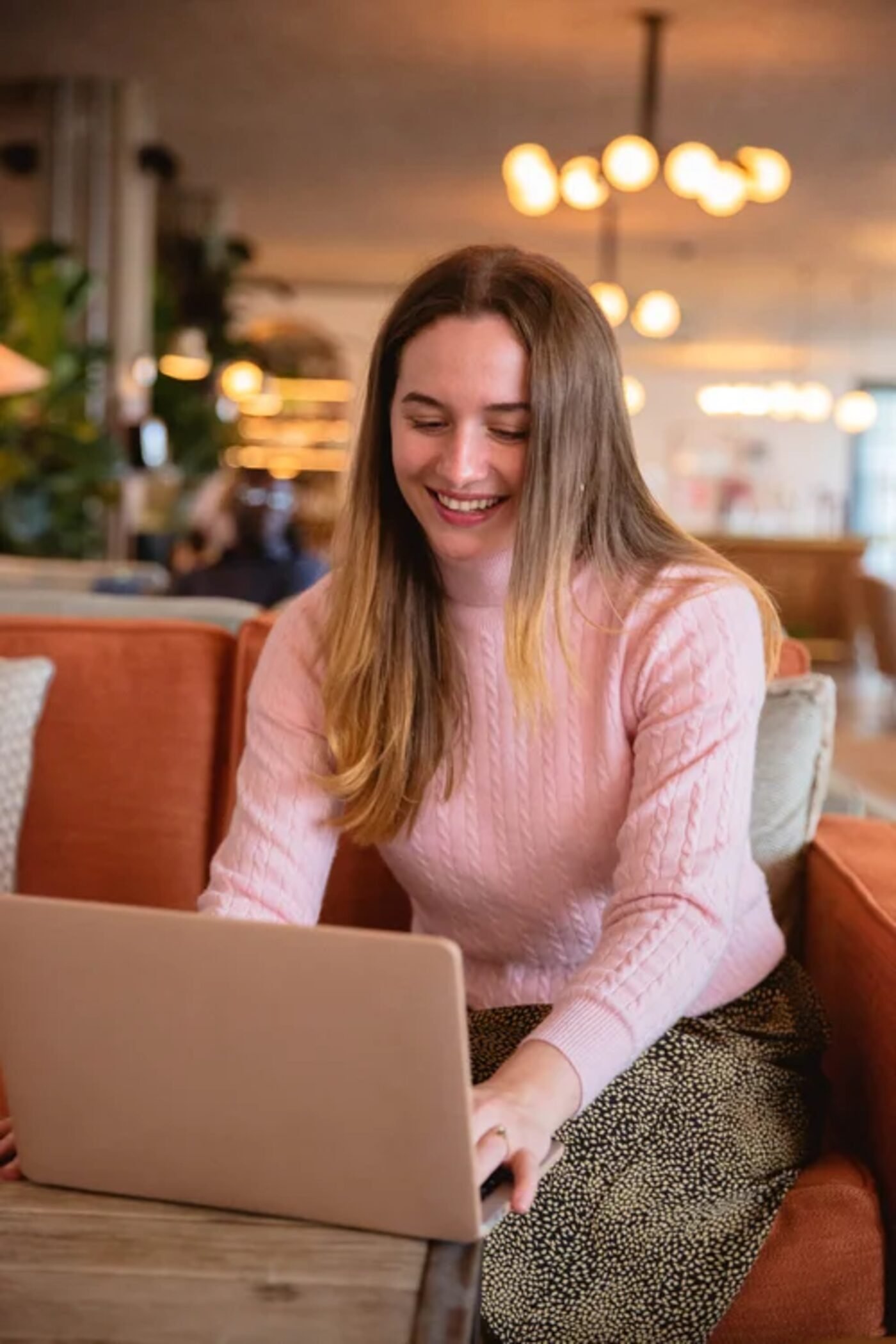 Hana Clode working on a laptop as an interiors marketing consultant